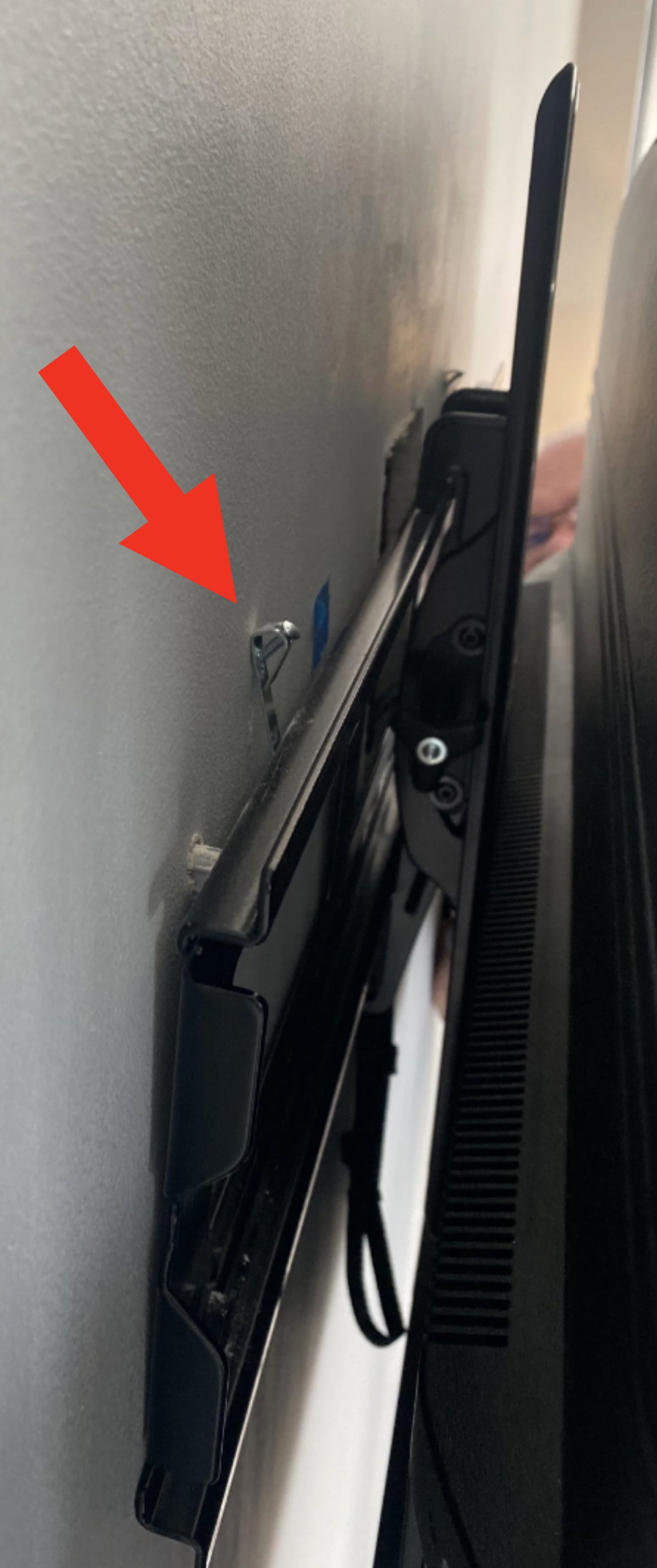 Picture hooks on a wall-mounted TV