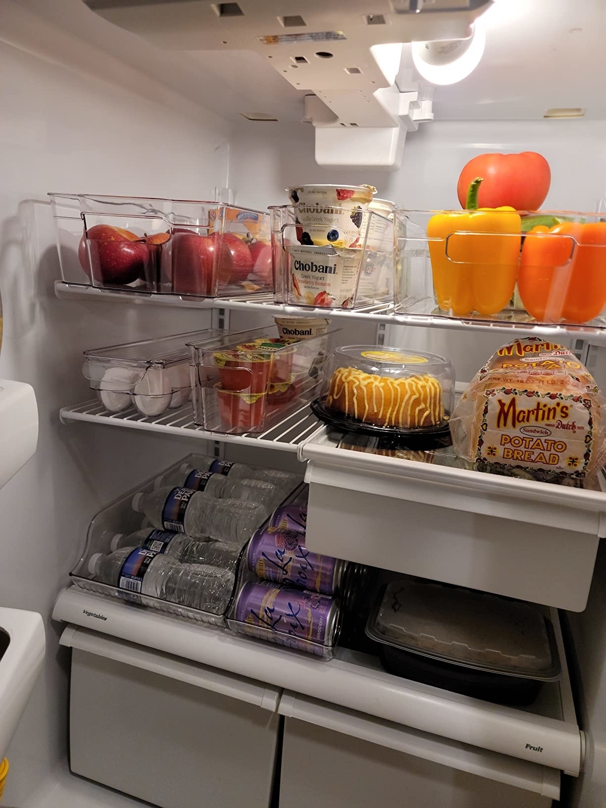 reviewer&#x27;s fridge with items organized in the clear bins