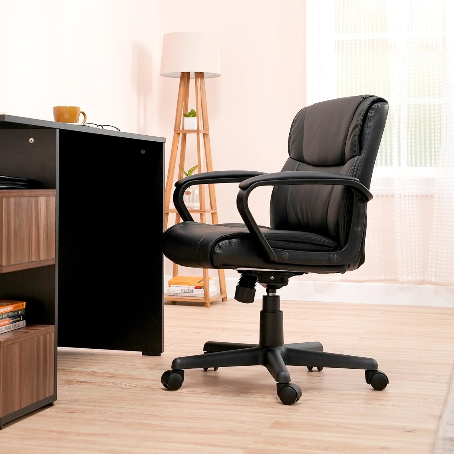 A black padded desk chair at a desk