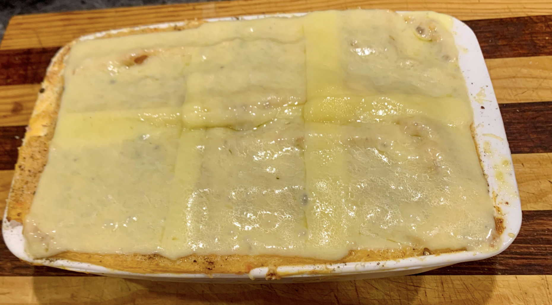 A pie covered in sandwich cheese