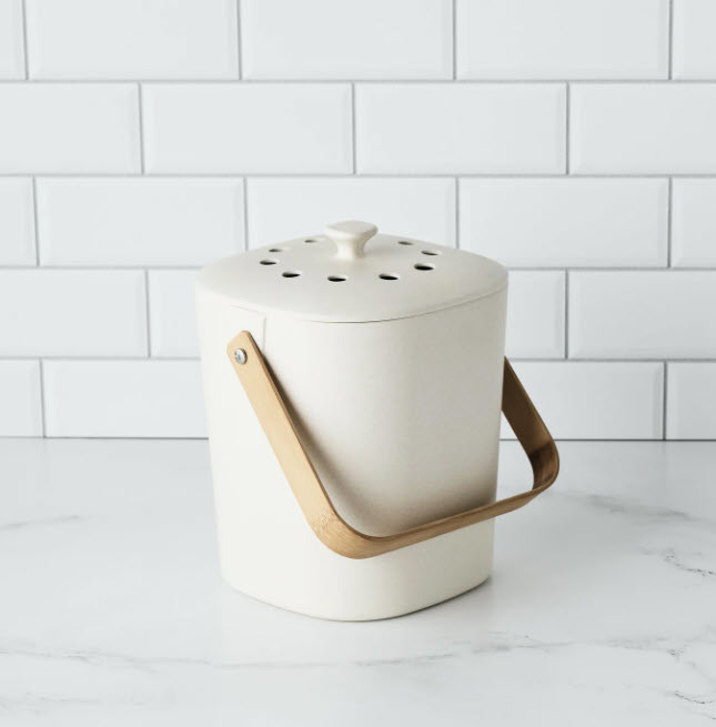white compost tin with wooden handle