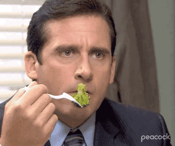 Michael from "The Office" reluctantly eating a bite of broccoli