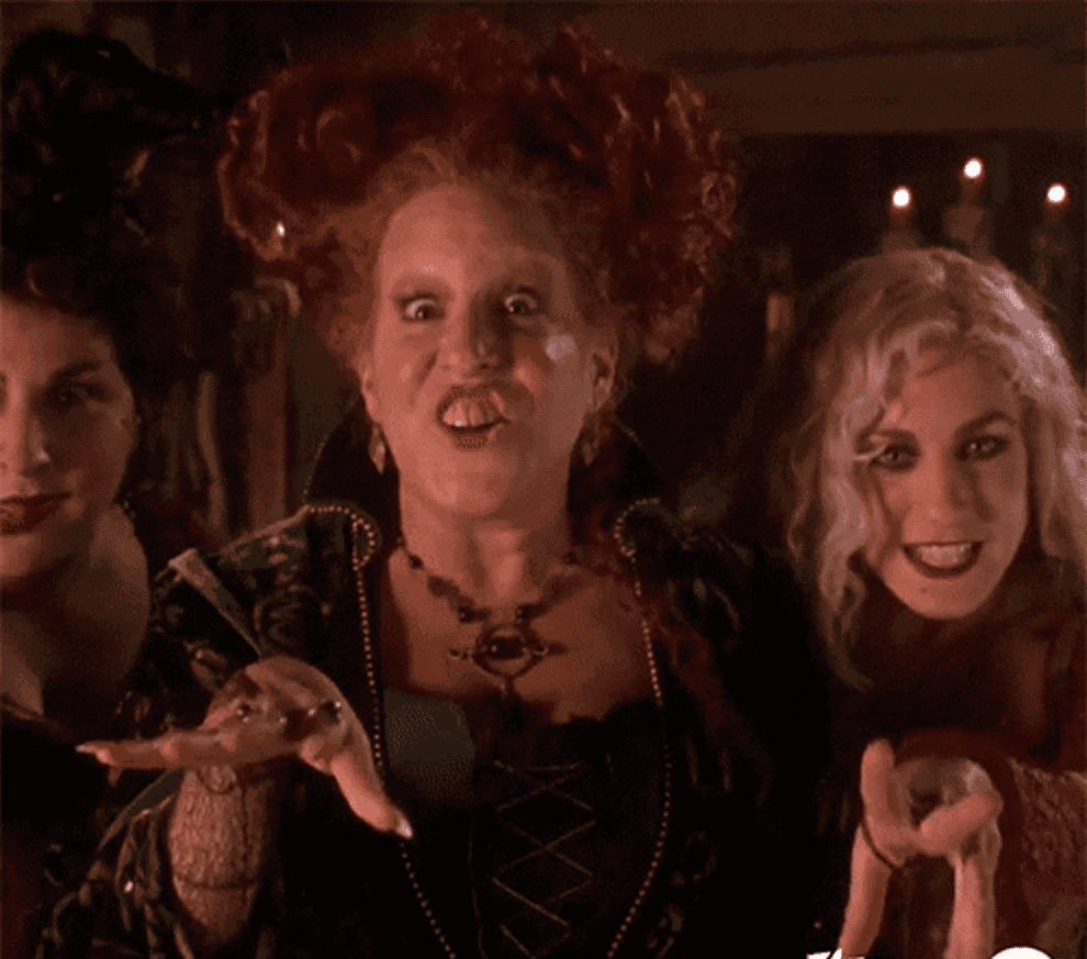 The witches from Hocus Pocus point at the camera.