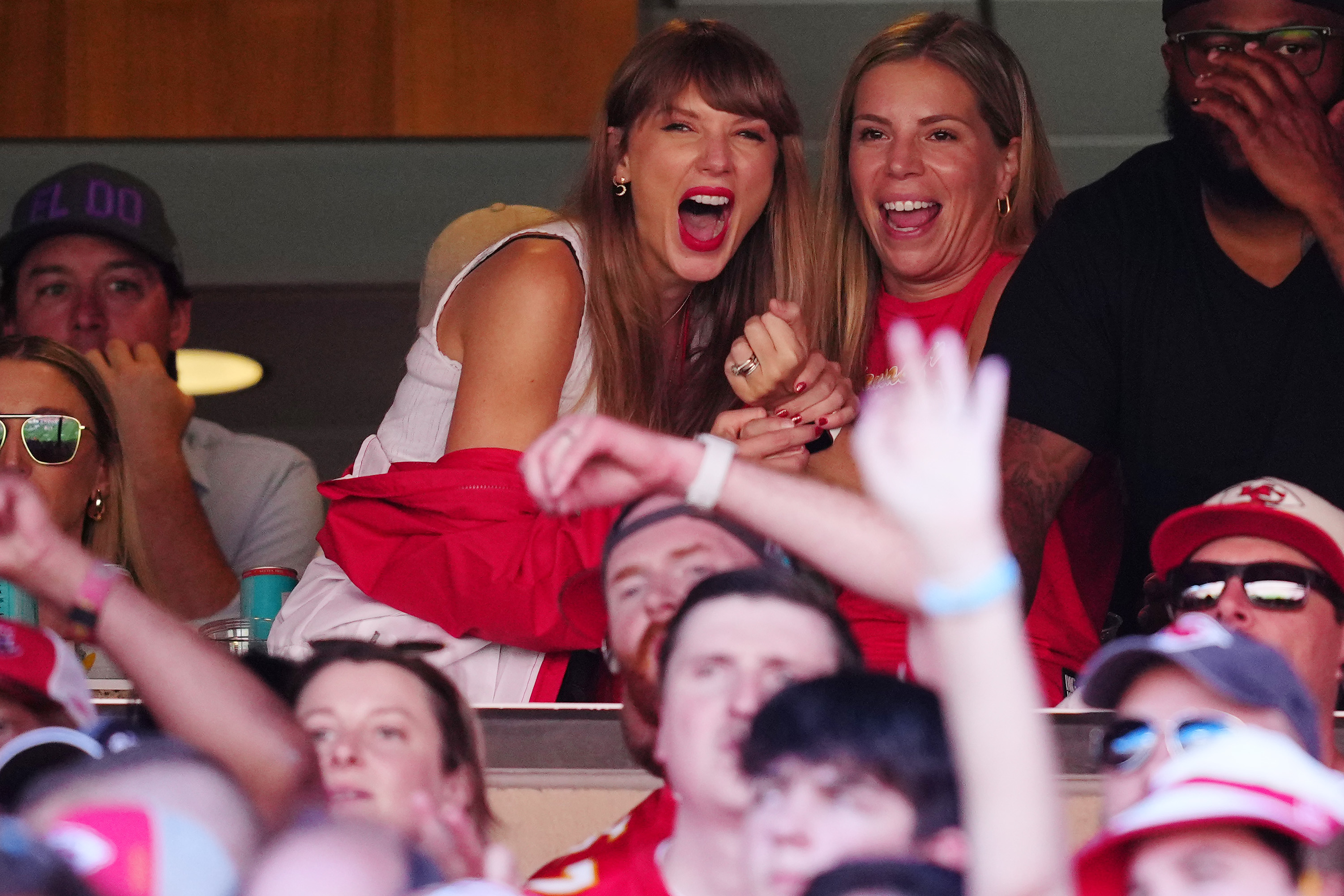 Close-up of Taylor in the VIP suite with others