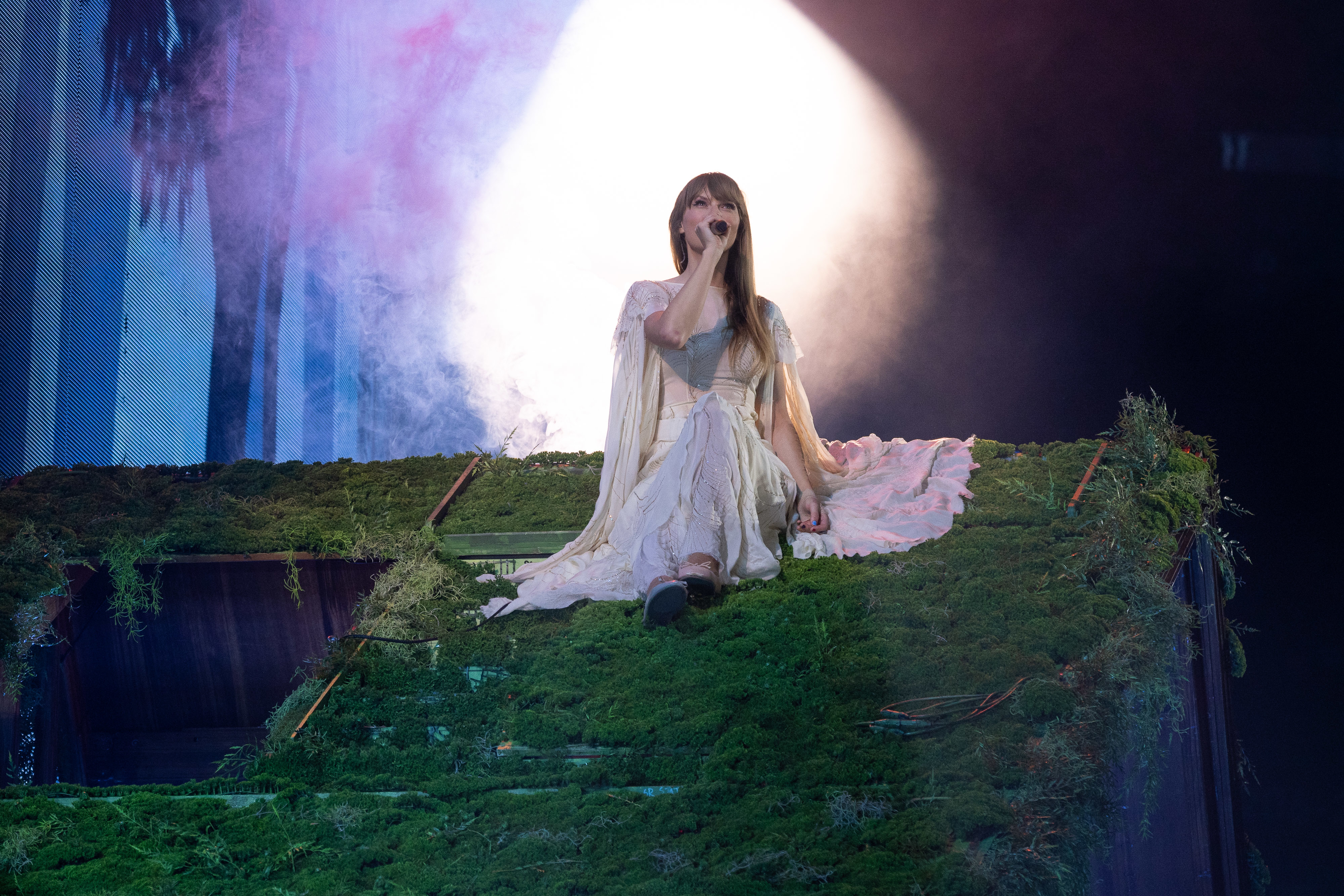 Taylor performing on a verdant roof