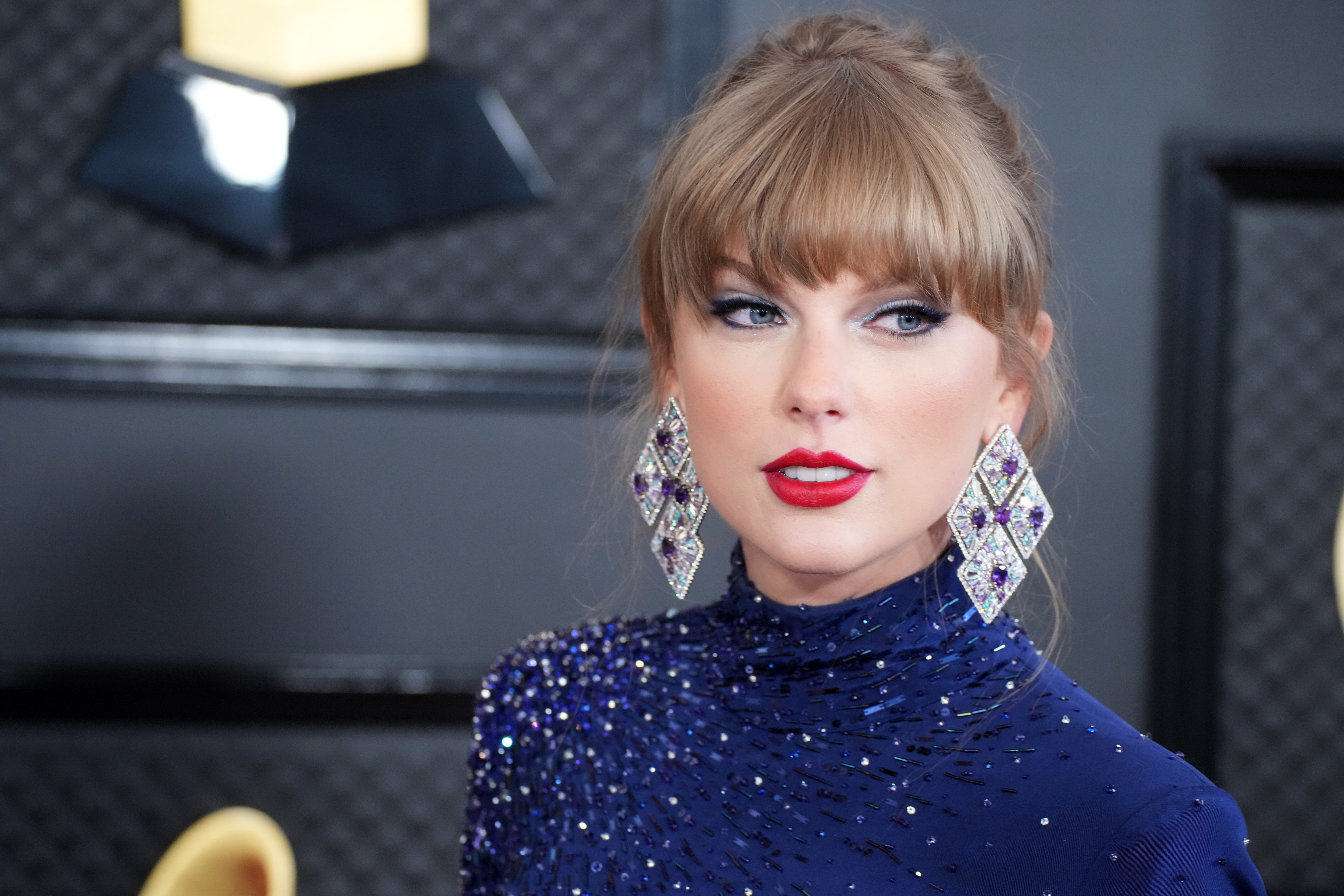 Close-up of Taylor wearing long, sparkly earrings