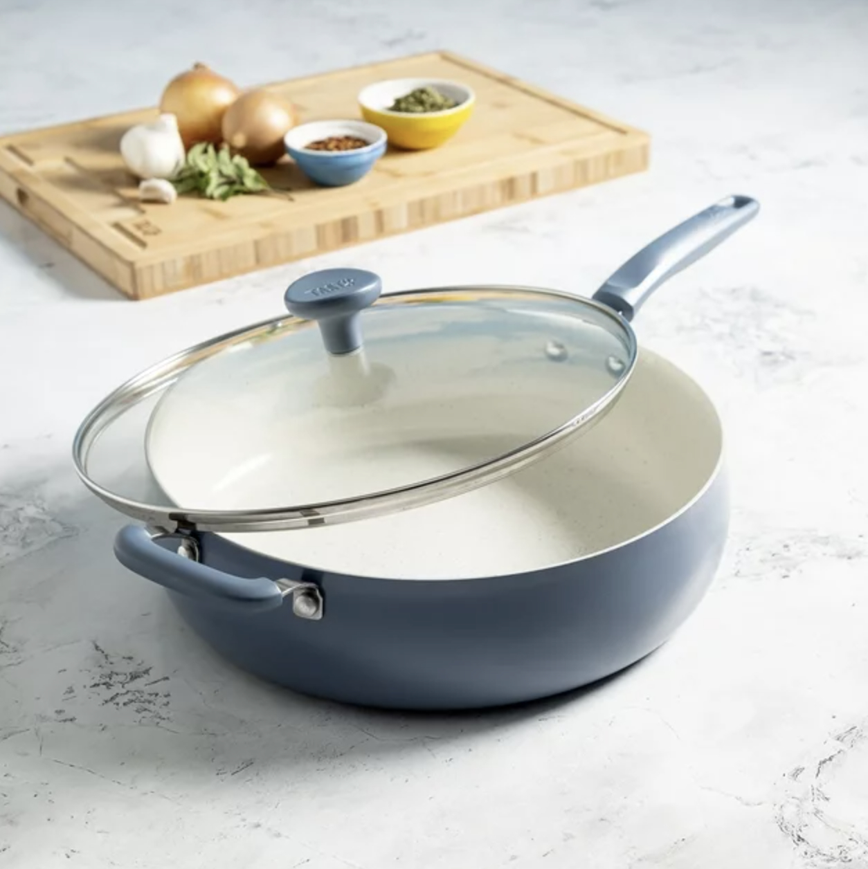 The grey blue pan with lid on countertop