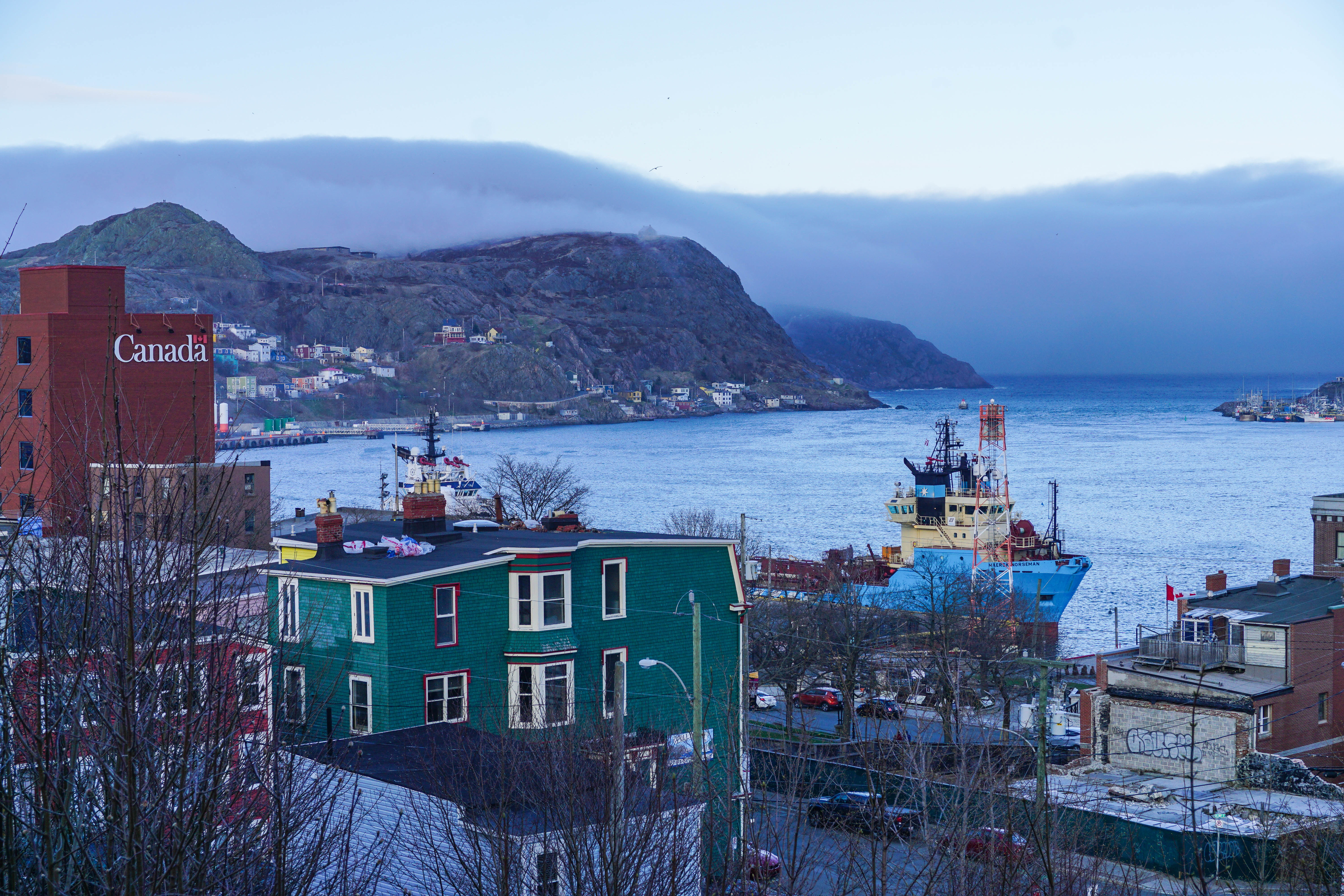City overlooking St. John&#x27;s Harbour with fog coming in.