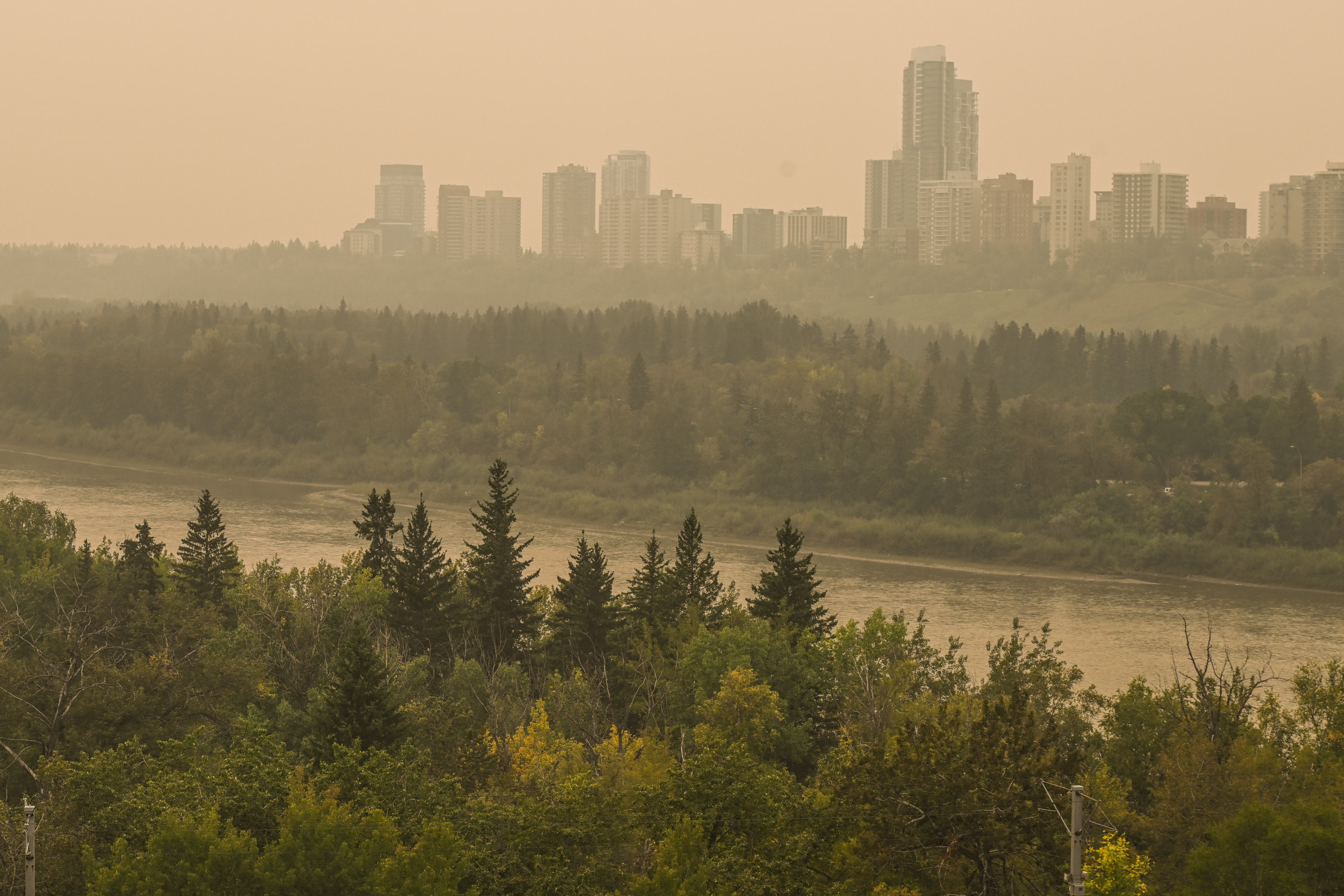 Saskatchewan forests and city skyline covered in haze.