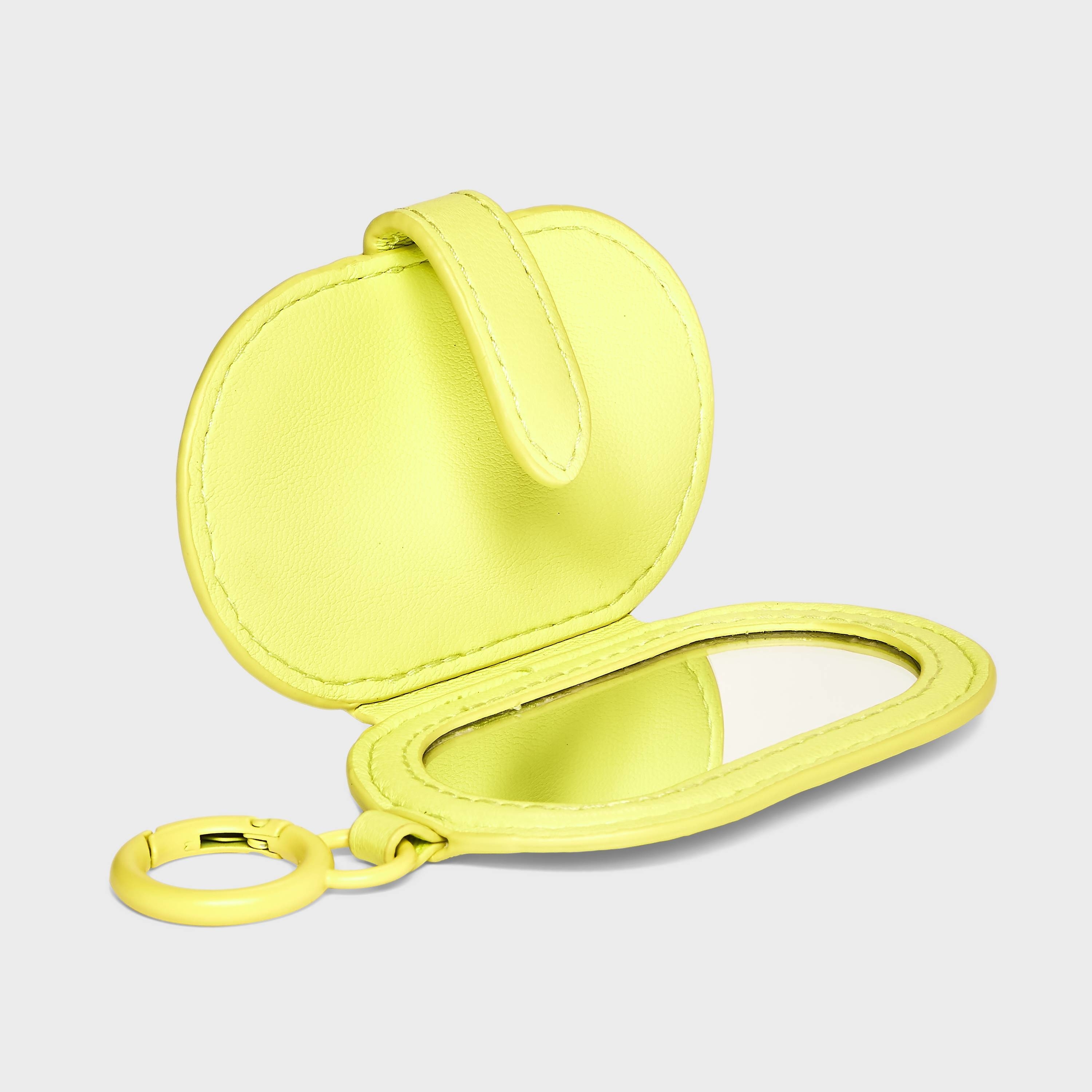An oval-shaped yellow mirror accessory