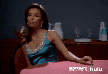 Eva Longoria in &quot;Desperate Housewives&quot; tapping her fingers on the table with an upset look on her face