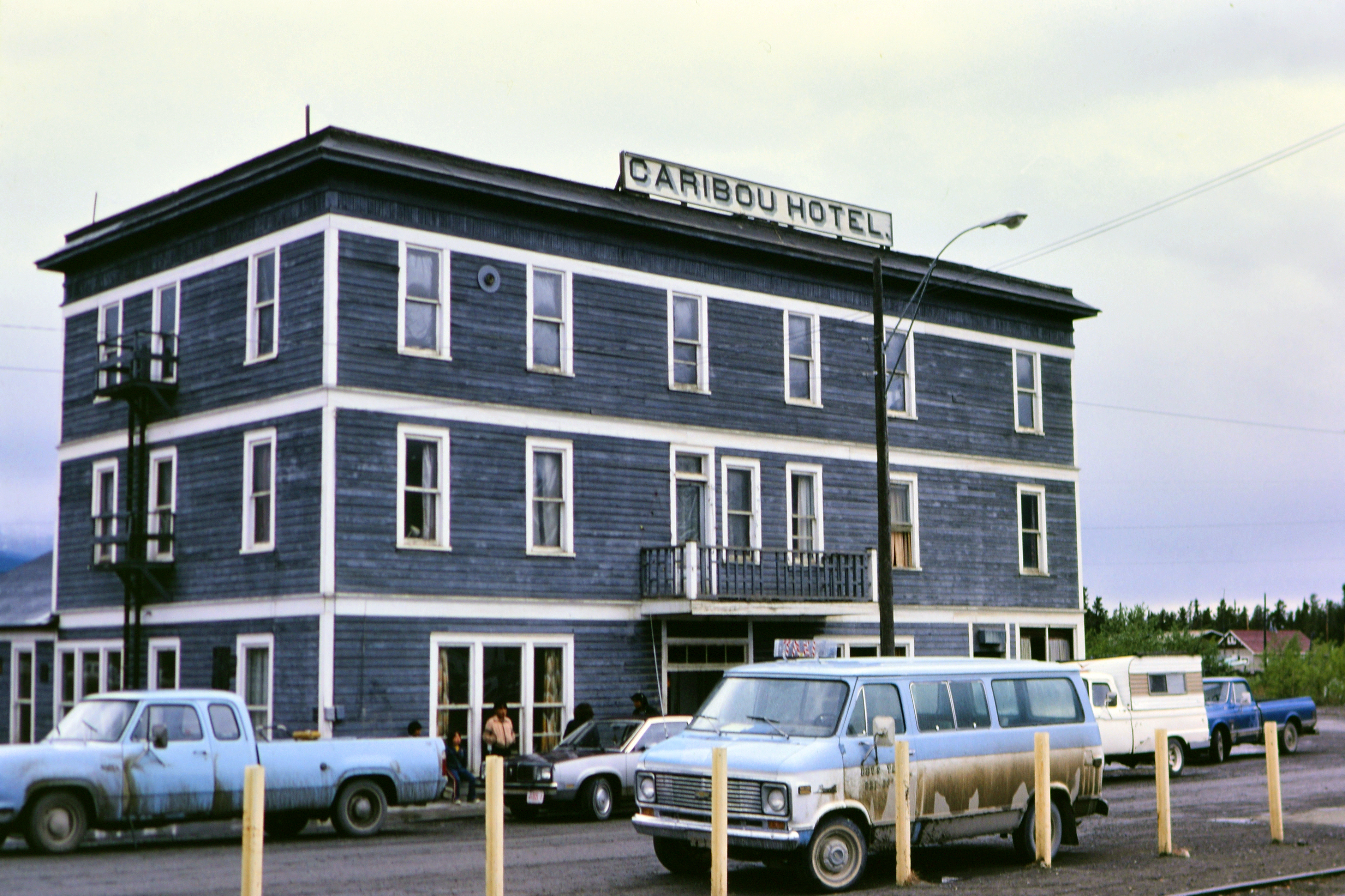 The Caribou Hotel in 1983 is surrounded by trucks and vans.