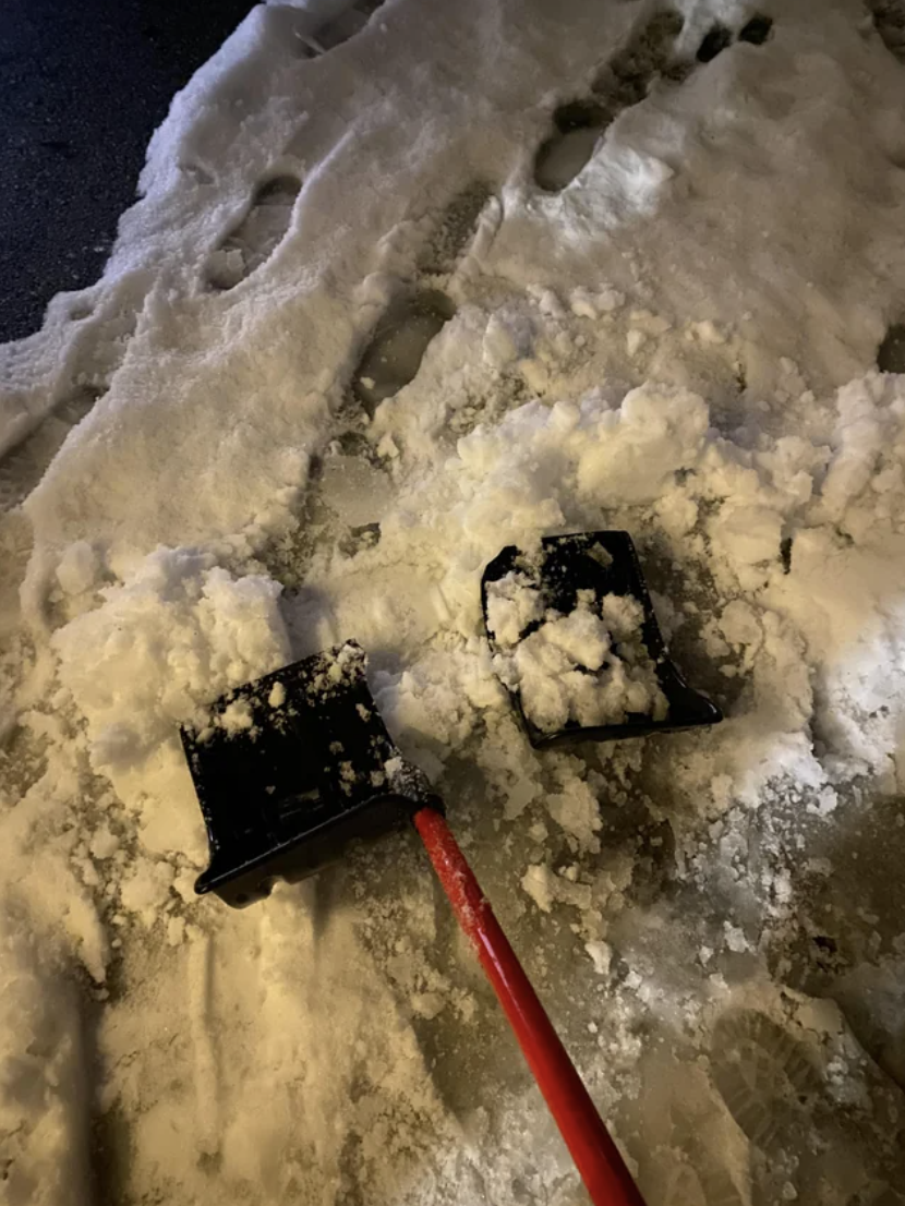 a broken shovel in snow