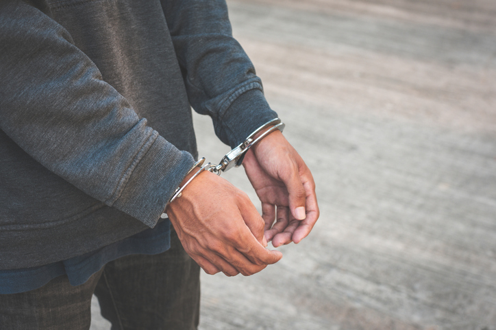 A man&#x27;s hands handcuffed