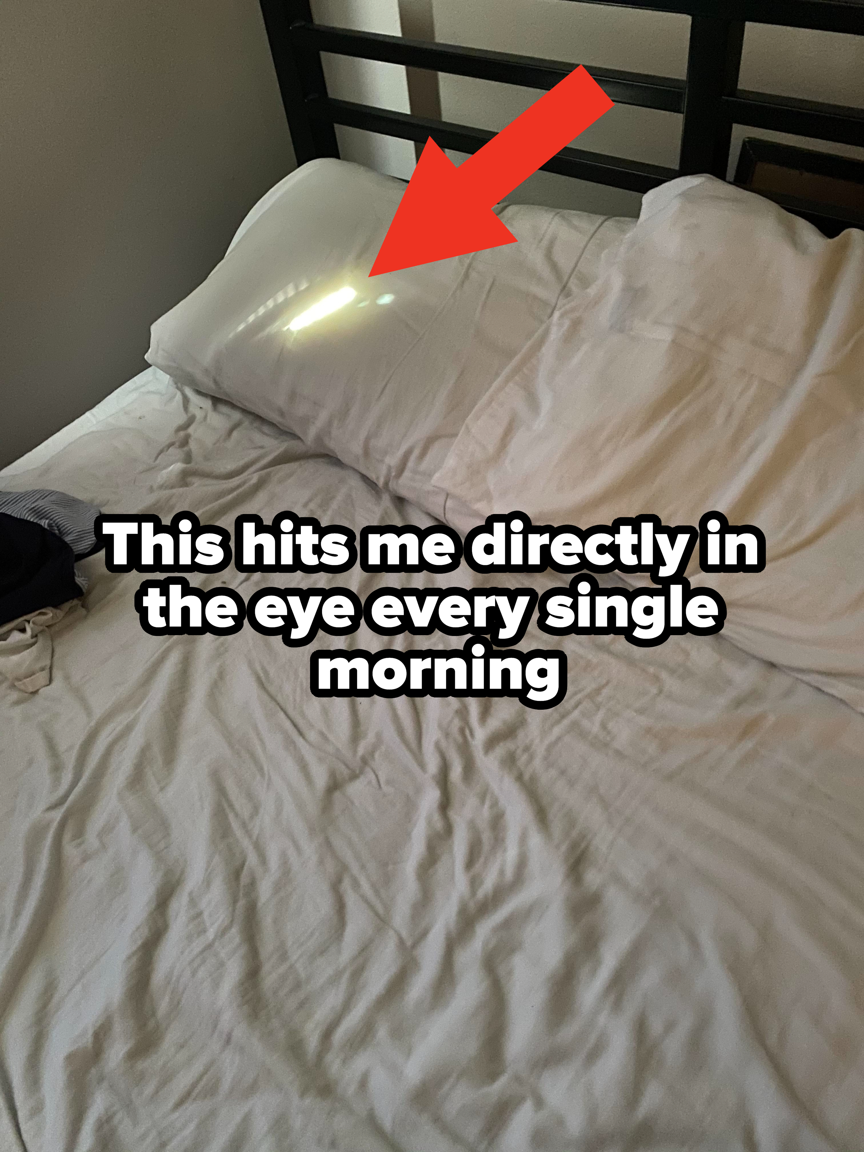 Arrow pointing to a sun spot on a pillow on a bed, with caption, &quot;This hits me directly in the eye every single morning&quot;