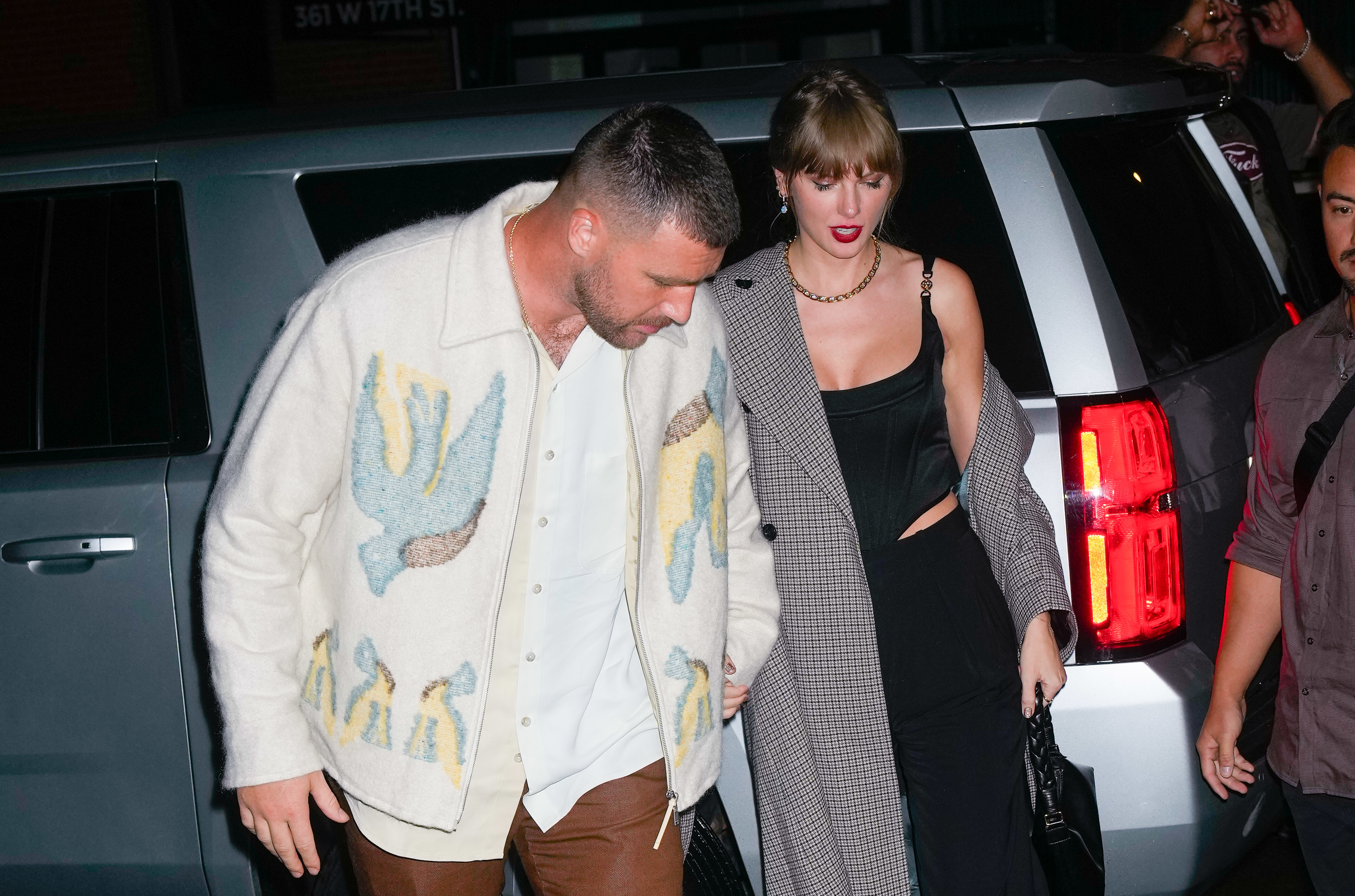 Travis and Taylor walking away from a car