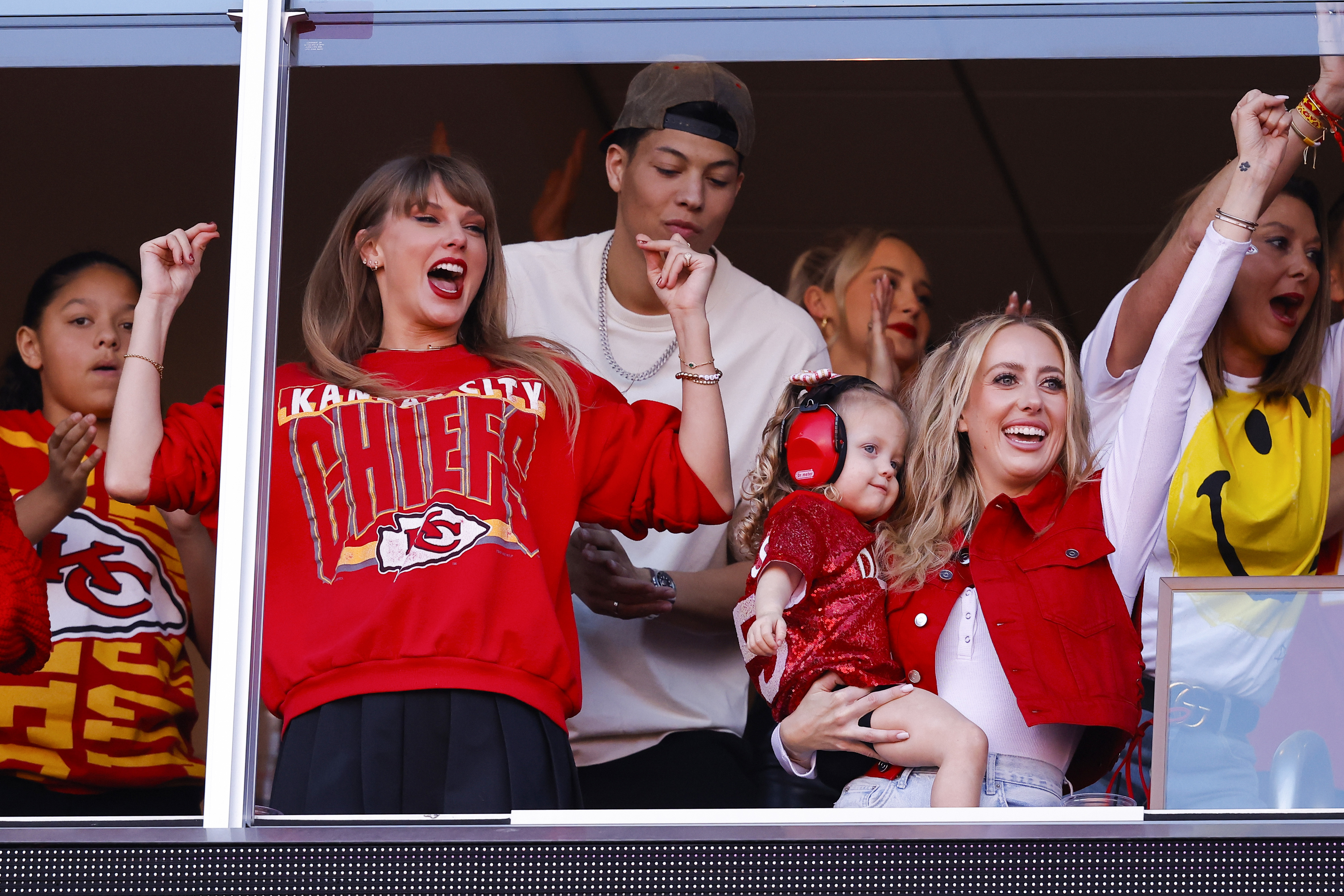 Close-up of Taylor and others cheering in the VIP lounge