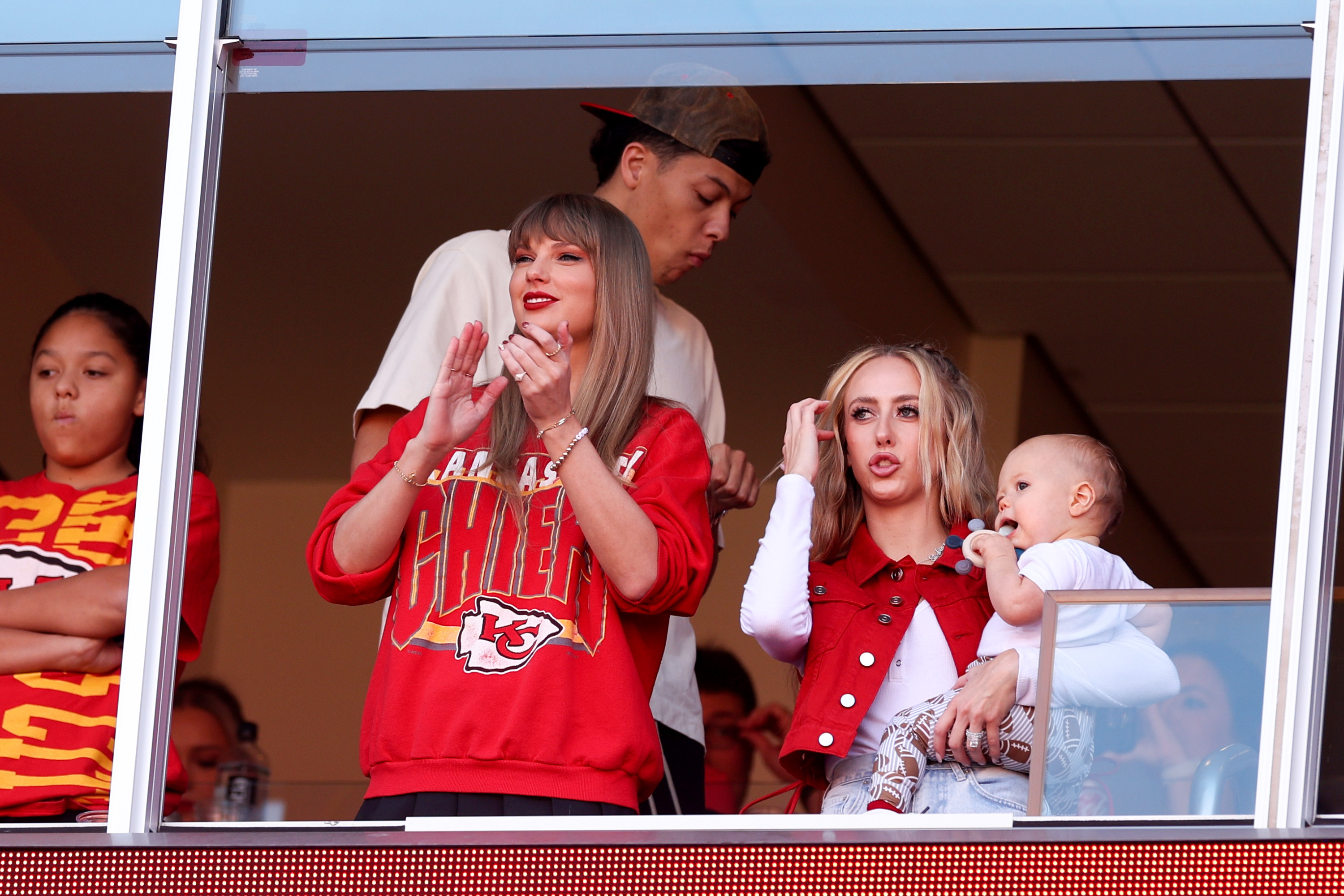 Close-up of Taylor clapping in the VIP section