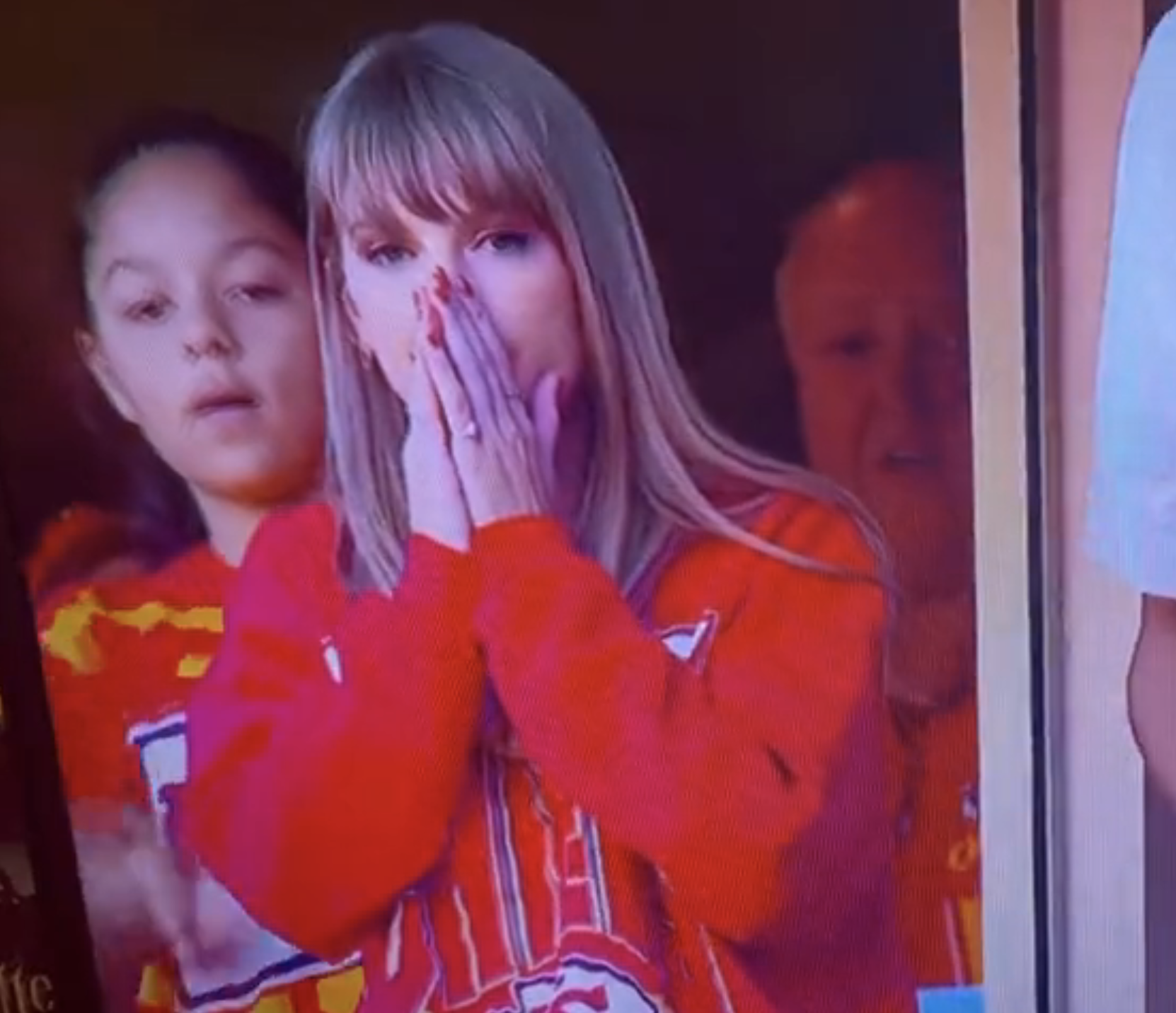 Close-up of Taylor with her hands covering her mouth