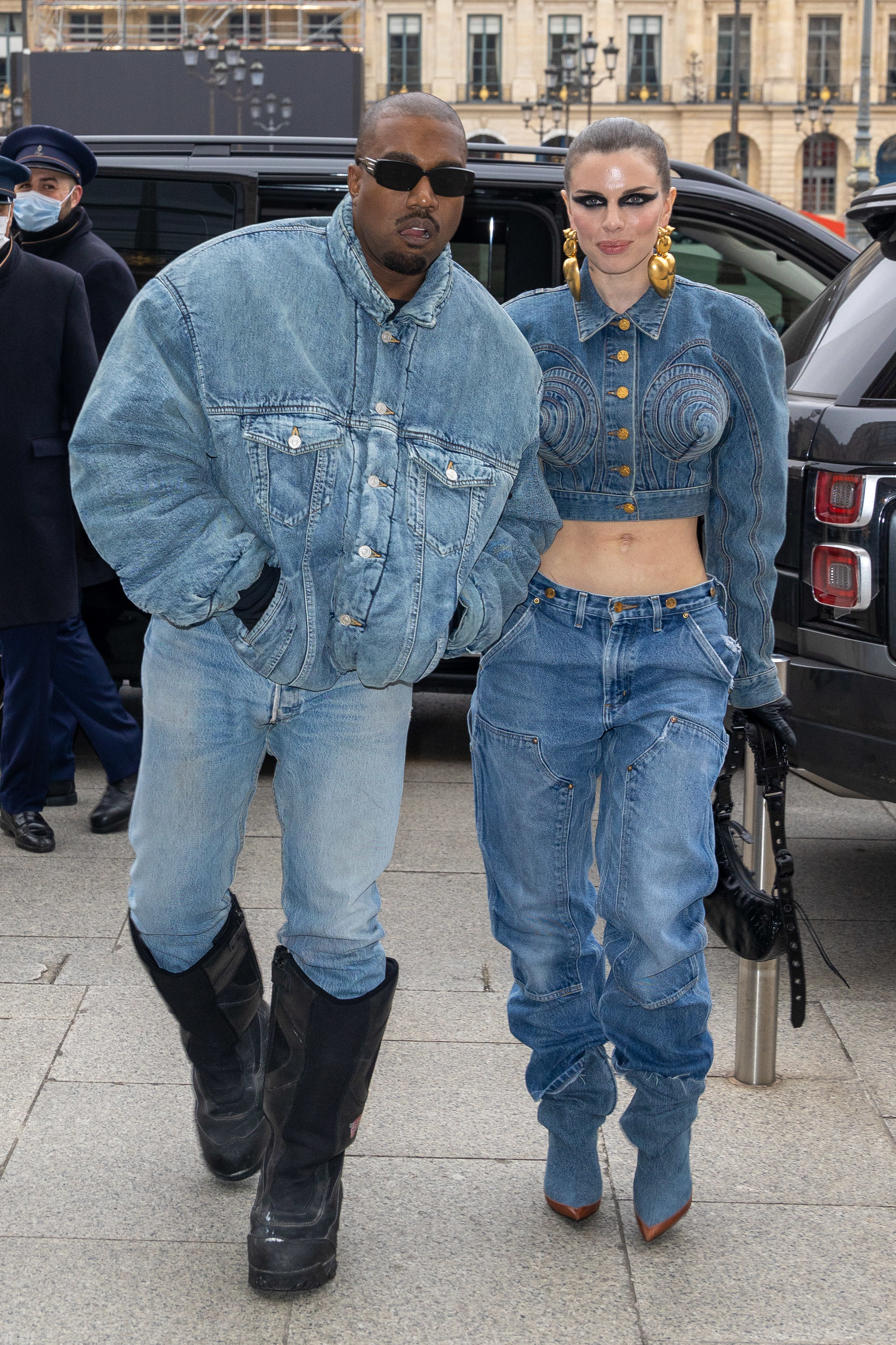 Close-up of Ye and Julia walking together and wearing denim