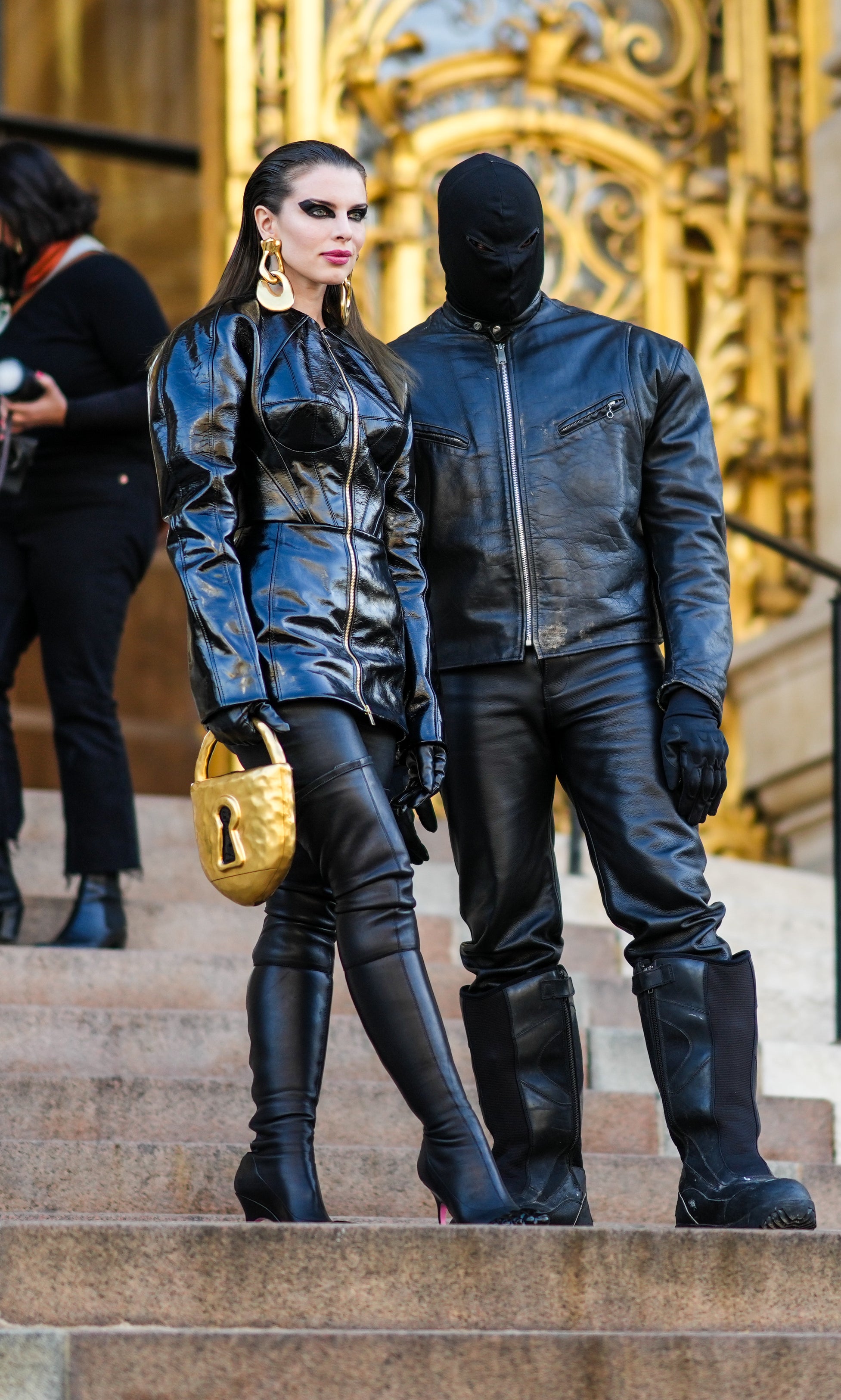 Close-up of Ye and Julia standing on steps and wearing leather
