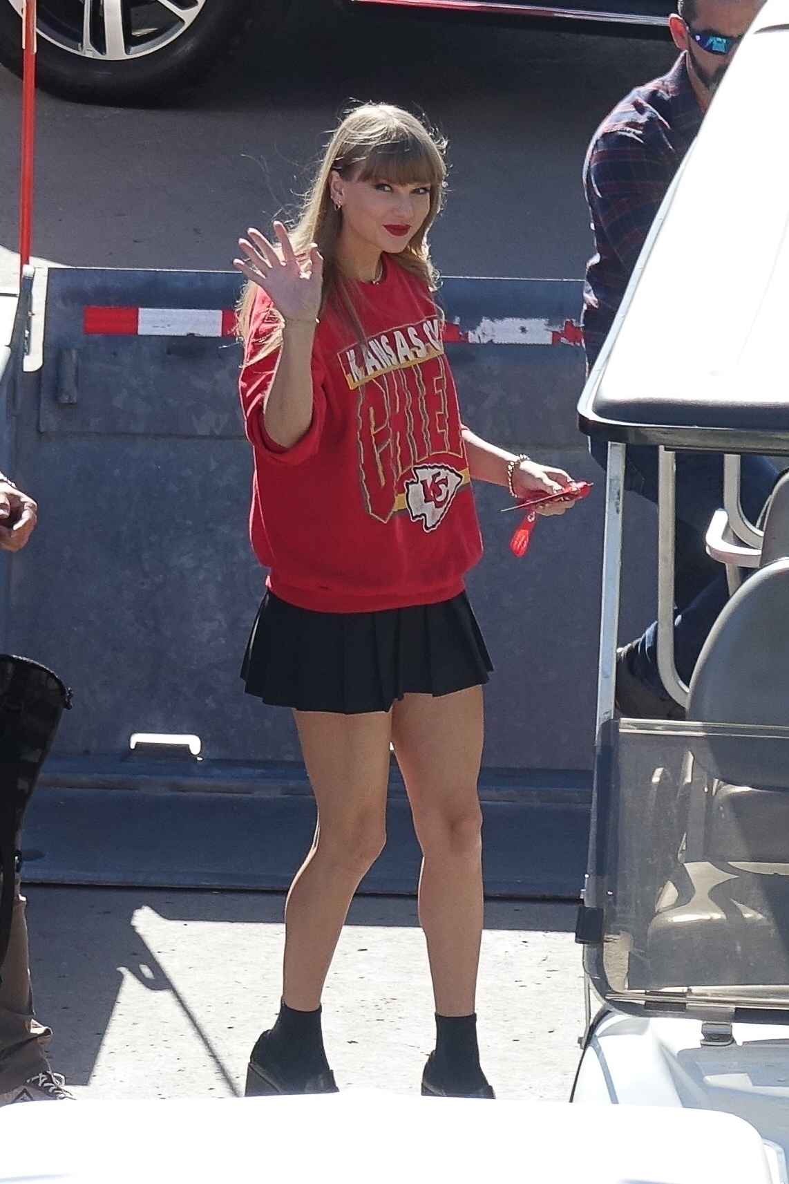 Taylor is wearing a Chief&#x27;s sweatshirt with a short pleated skirt