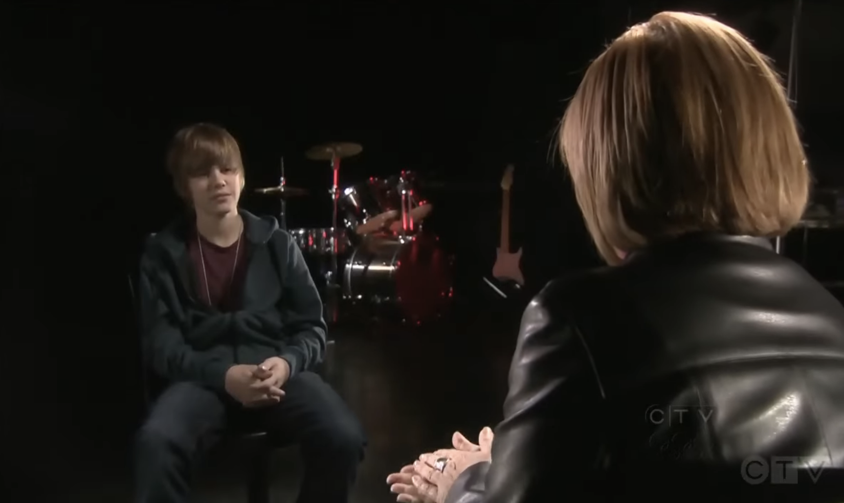 Close-up of Justin sitting opposite an interviewer