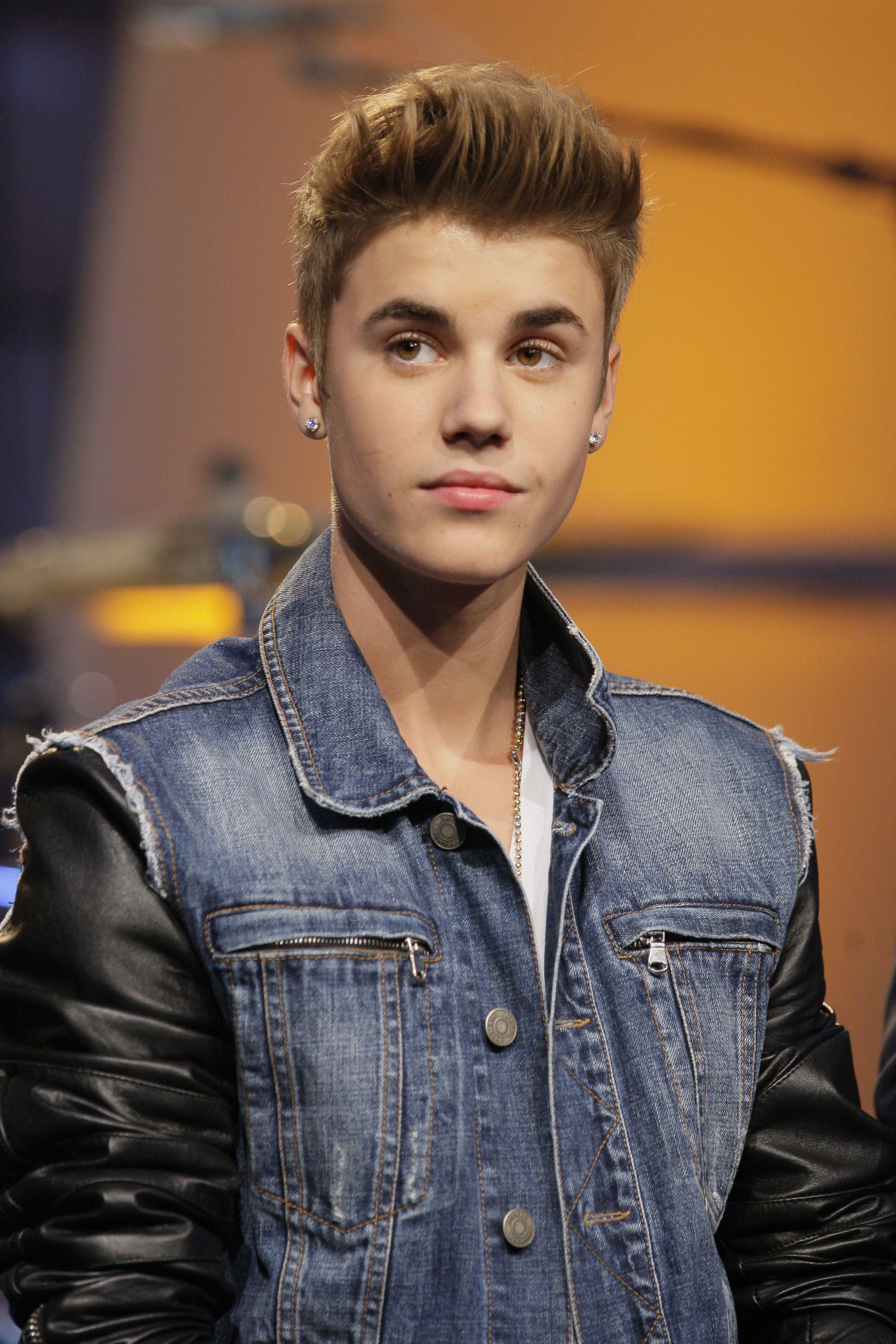 Close-up of Justin as a teen in denim and his hair in an updo