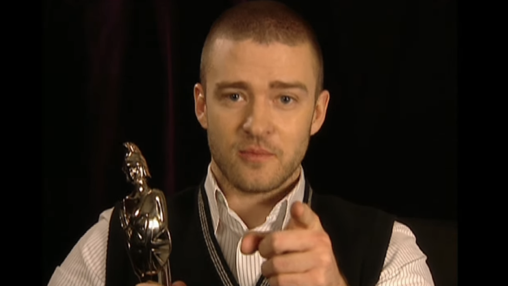 Closeup of Justin holding an award