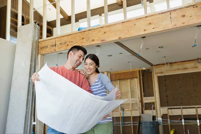 A couple looking at plans for a renovation