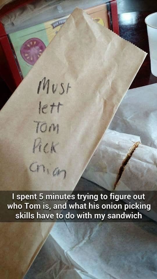 Takeout food bag with writing that says &quot;must lett tom pick onion&quot;