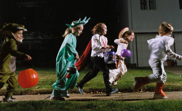 Kids in Halloween costumes trick-or-treating