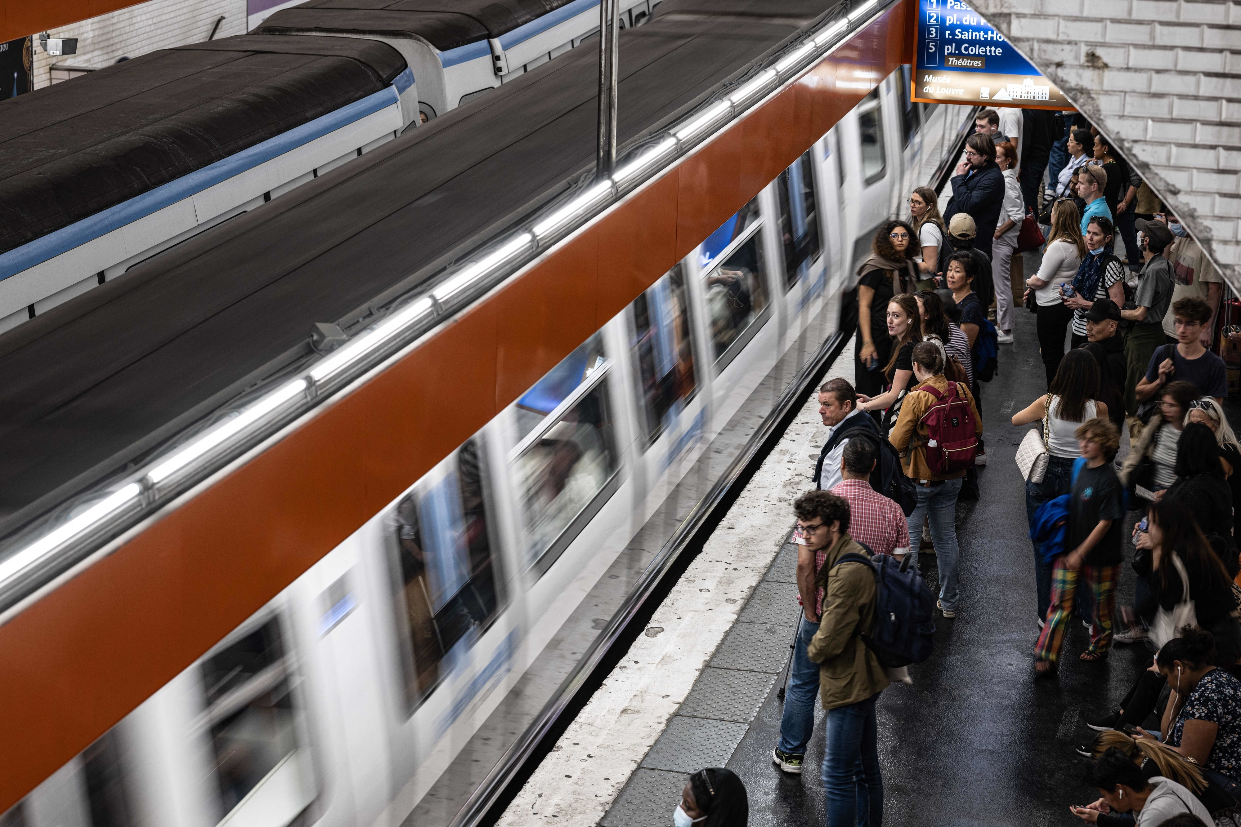 passengers waiting for a train in the paris metro