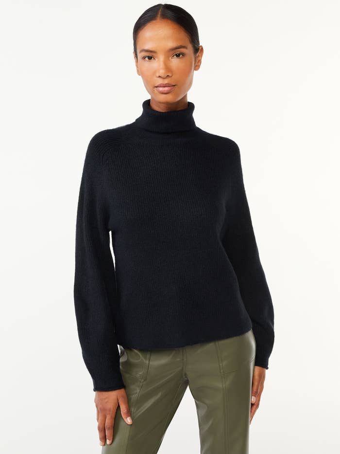 a model wearing the black sweater