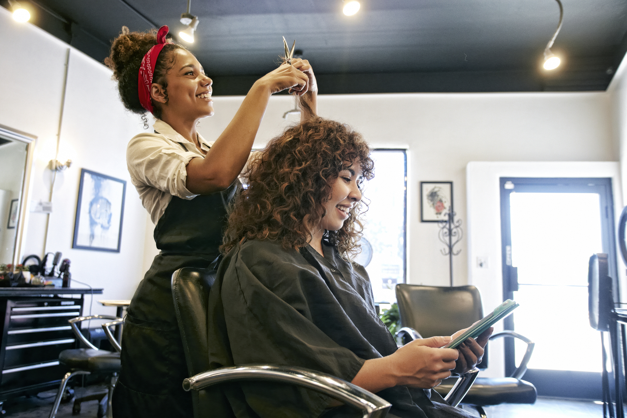 A woman is getting her hair done at the salon