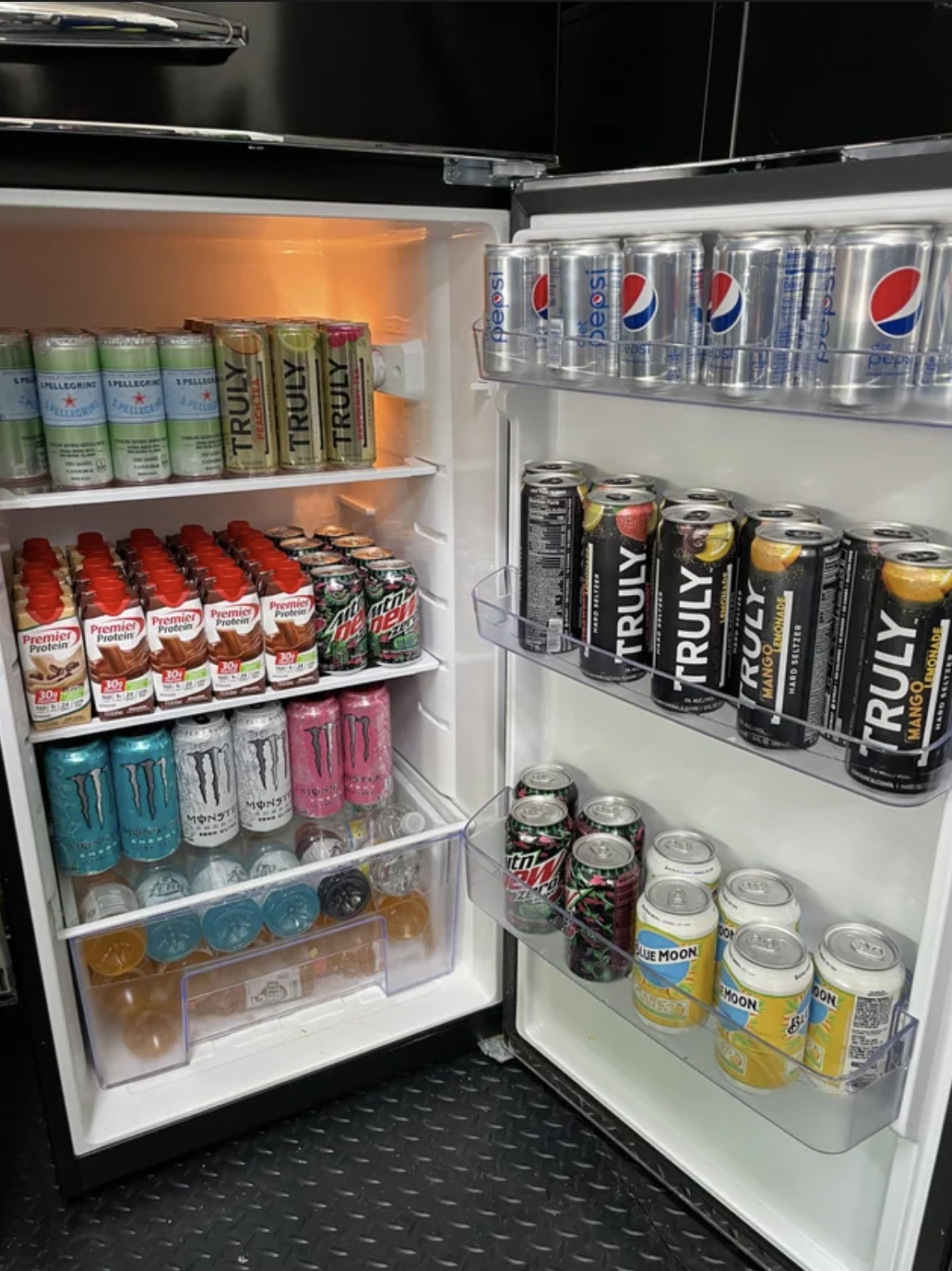 A fridge is filled with a variety of drinks
