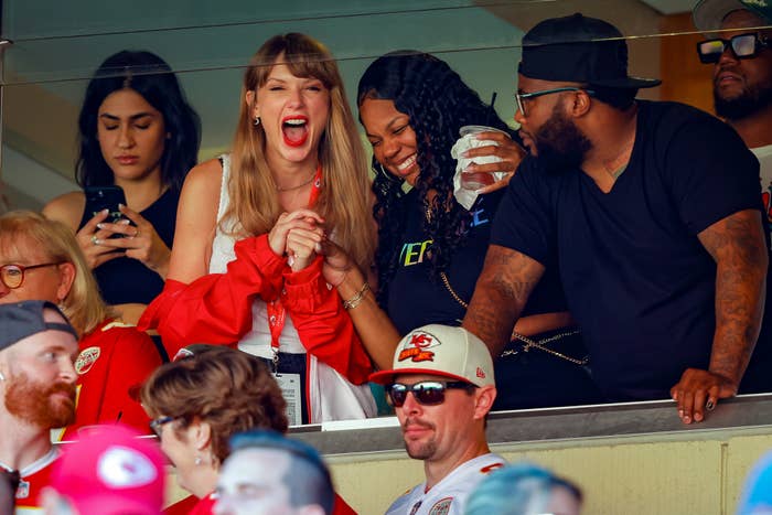taylor cheering in the suite with her friends