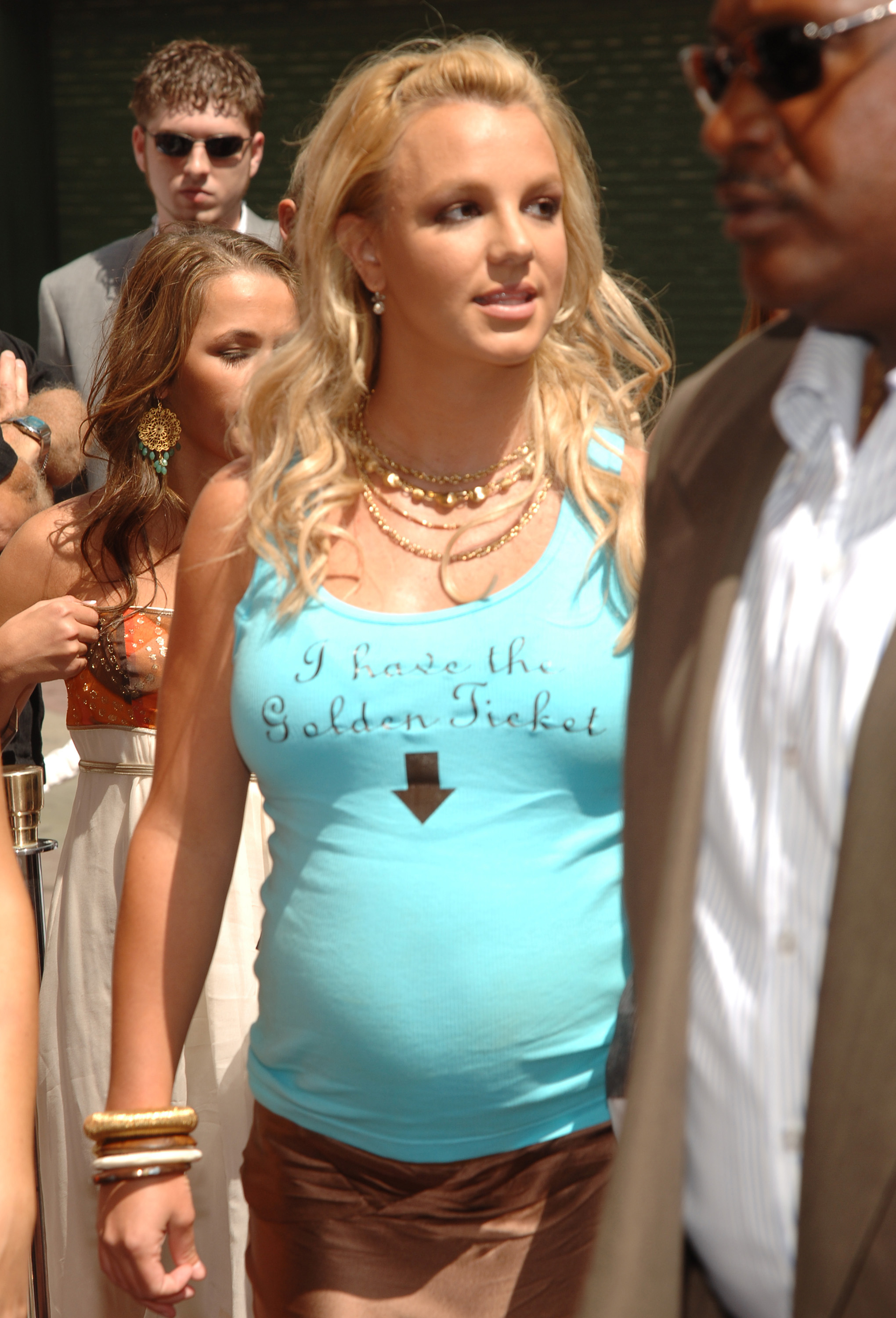 a pregnant britney wearing a shirt that reads &quot;i have the golden ticket&quot; with an arrow pointing to her belly
