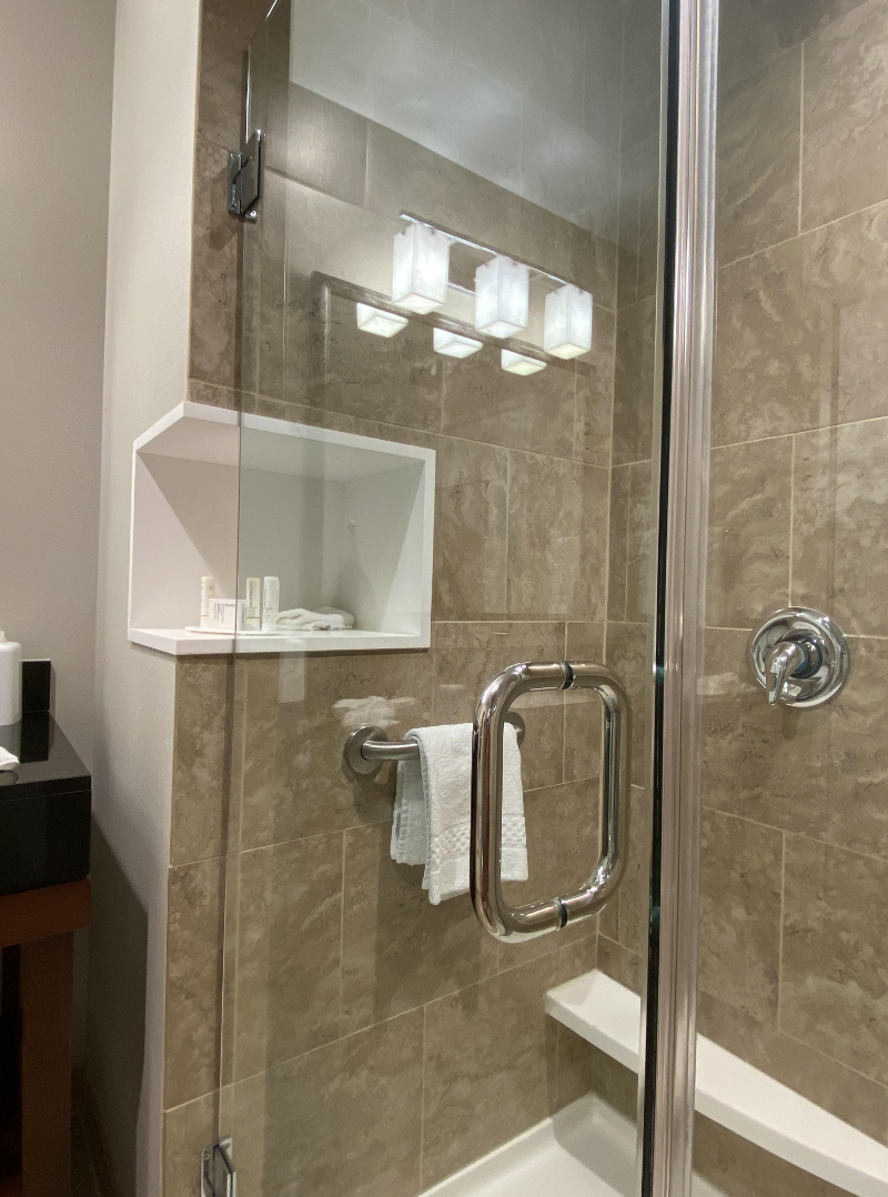 a shelf that extends outside the shower