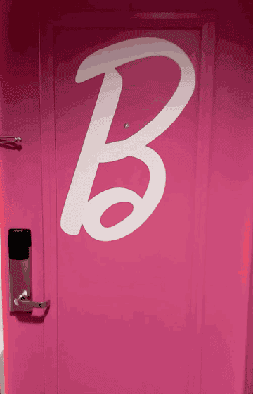 A video of the pink door being opened revealing the entrance of the pink