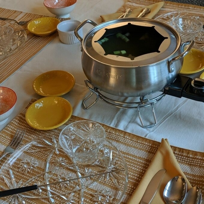 the fondue set in silver on a reviewer&#x27;s table