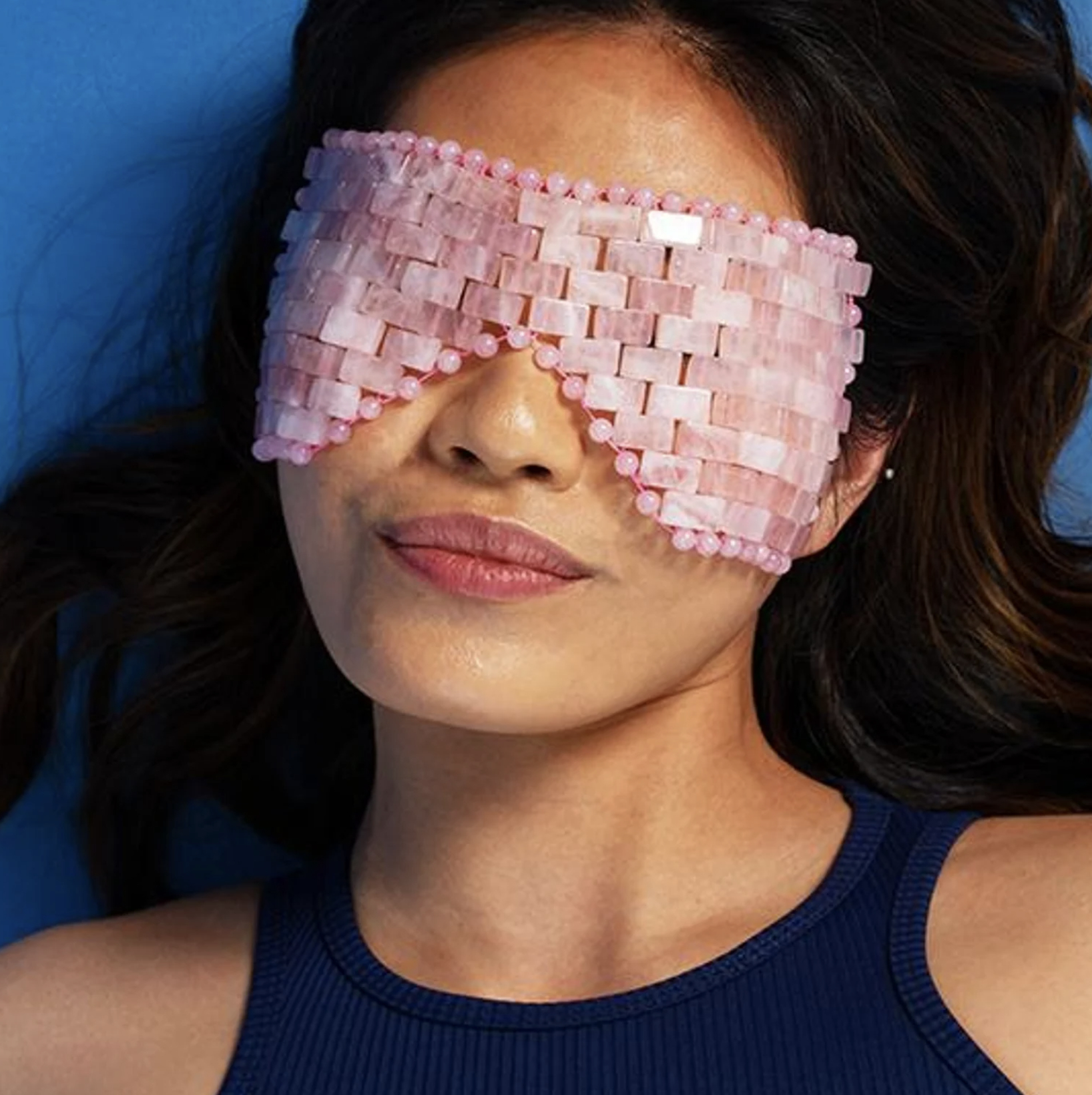 a person wearing the pink rose quartz eye mask