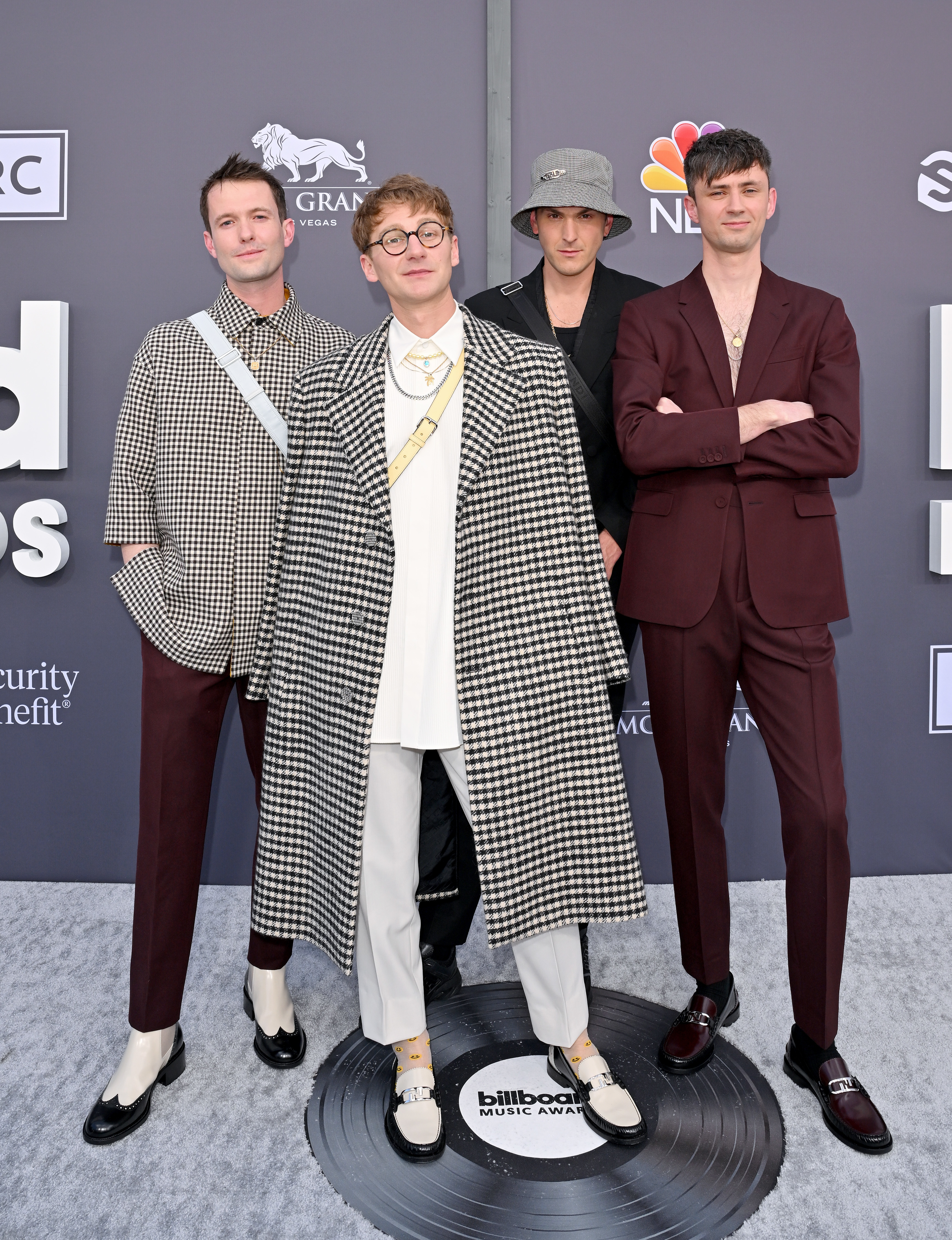 The four band members at a media event