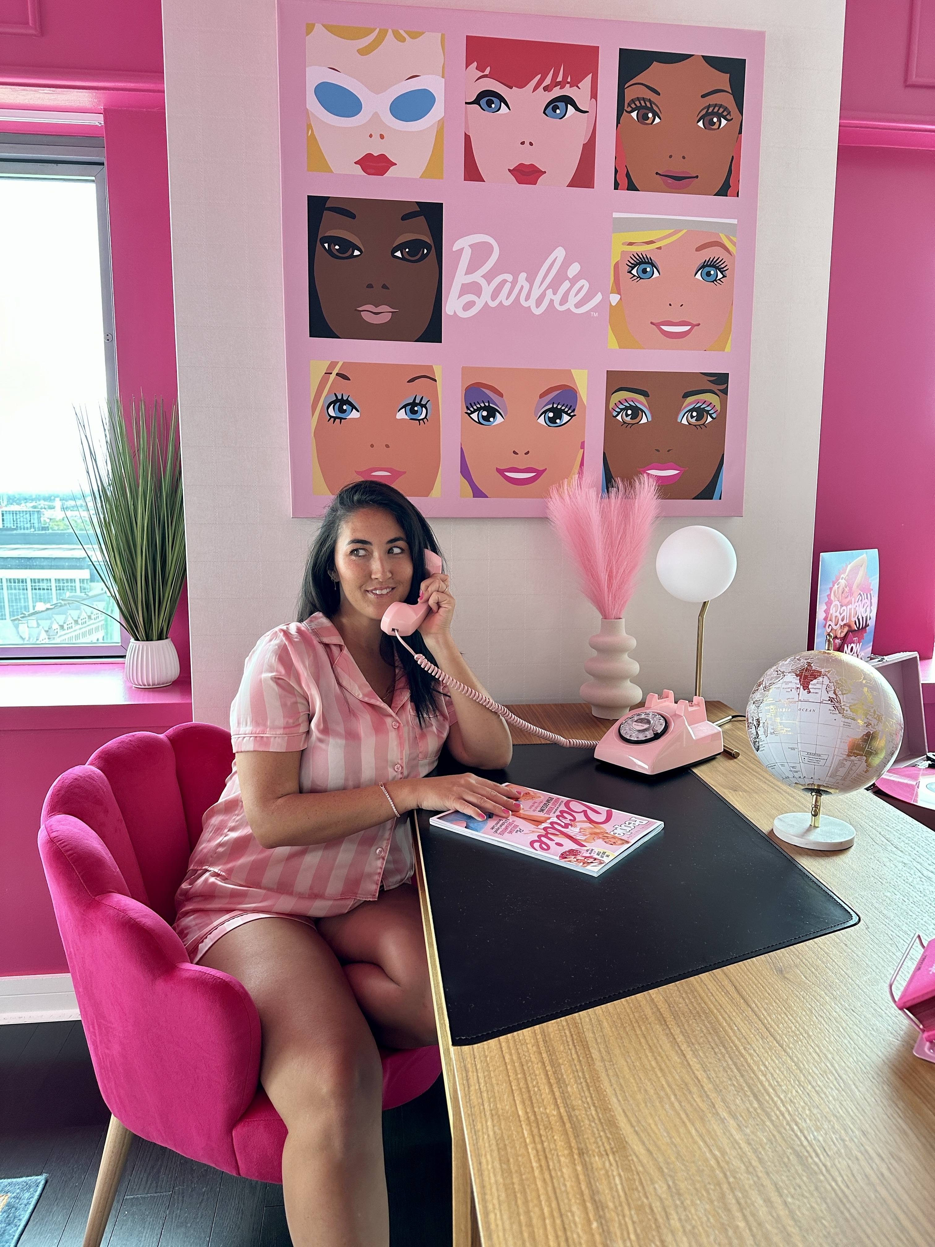 The author sitting at a Barbie themed desk on the phone