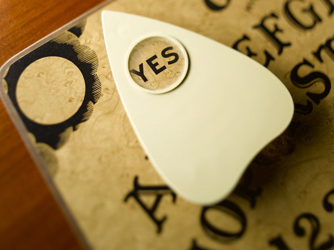 a ouija board with the planchette on yes