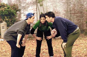 Chandler, Rachel, and Ross playing football.