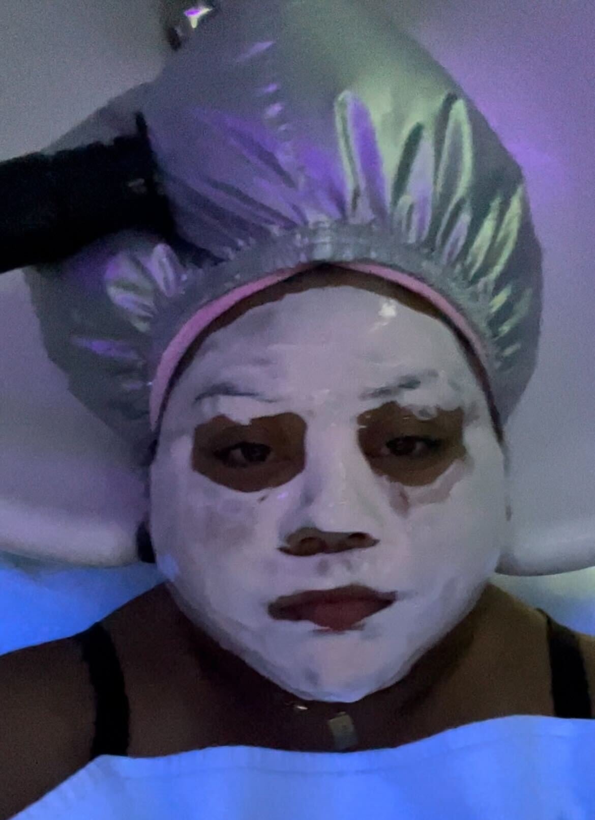 The author has a face mask on and her cap looks as if it's about to explode
