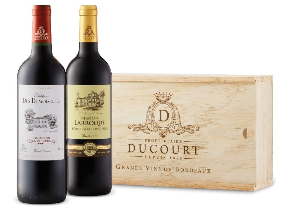 Château des Demoiselles and Château Larroque 2020 and their wooden box on a blank background
