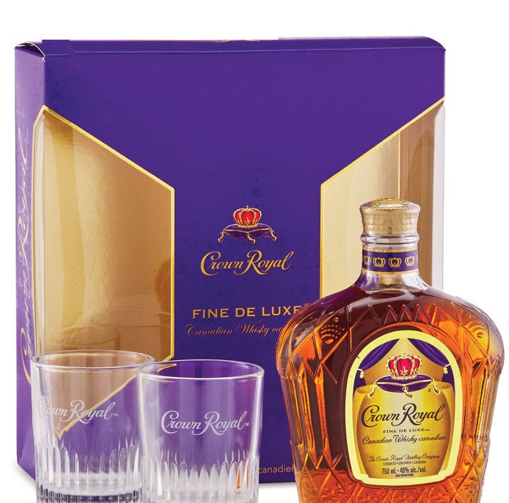 A bottle of Crown Royal and two glasses in front of a gift box