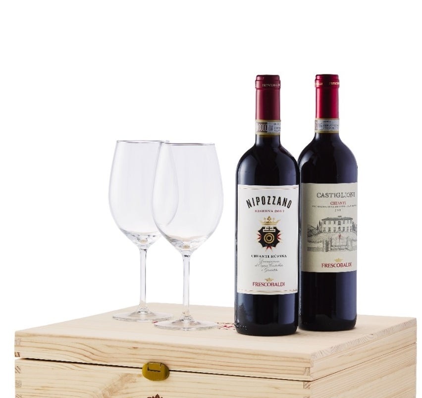 Two bottles of wine and two wine glasses on top of a wooden gift box